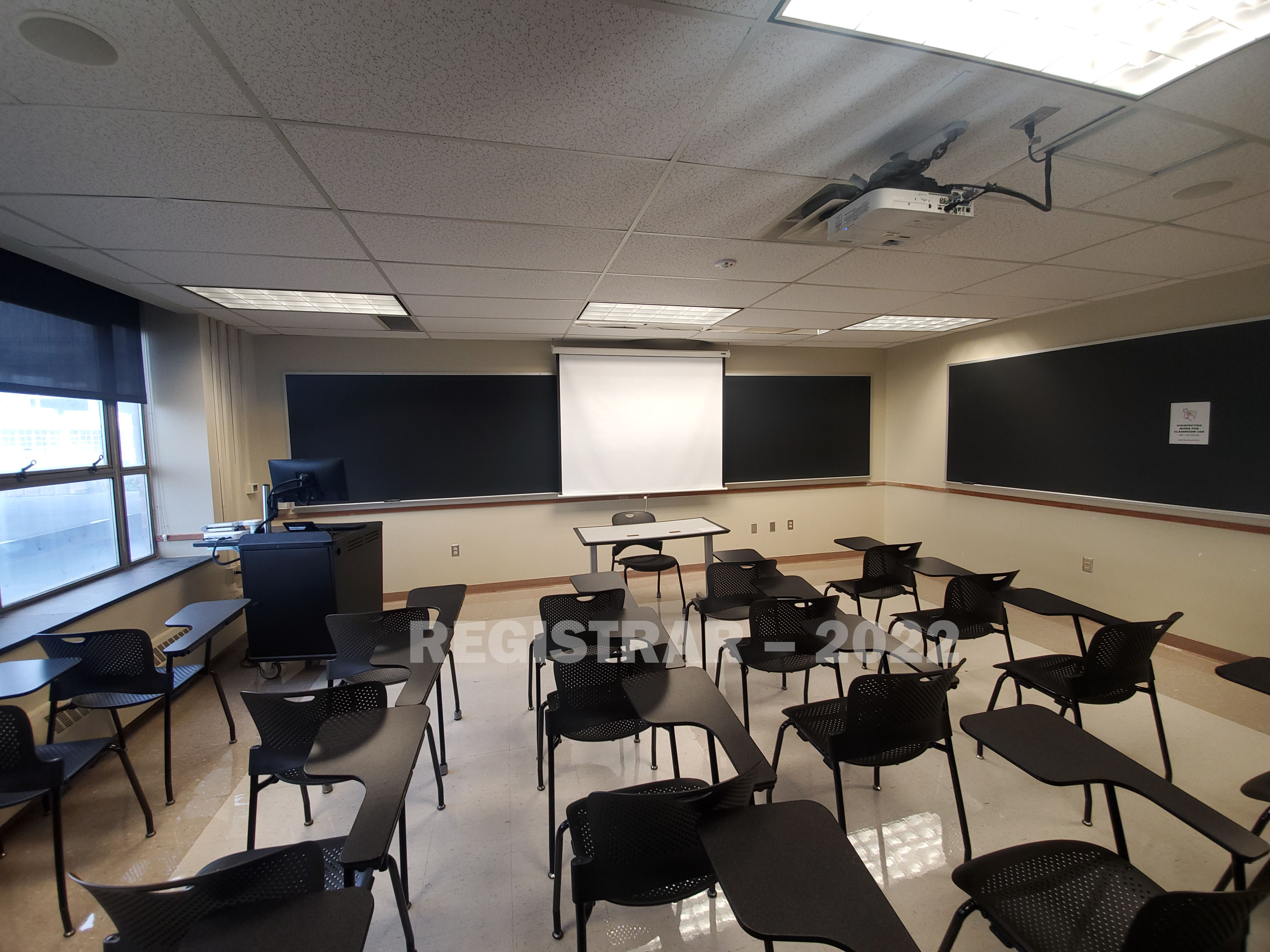Enarson Classroom Building room 246 ultra wide angle view from the back of the room with projector screen down