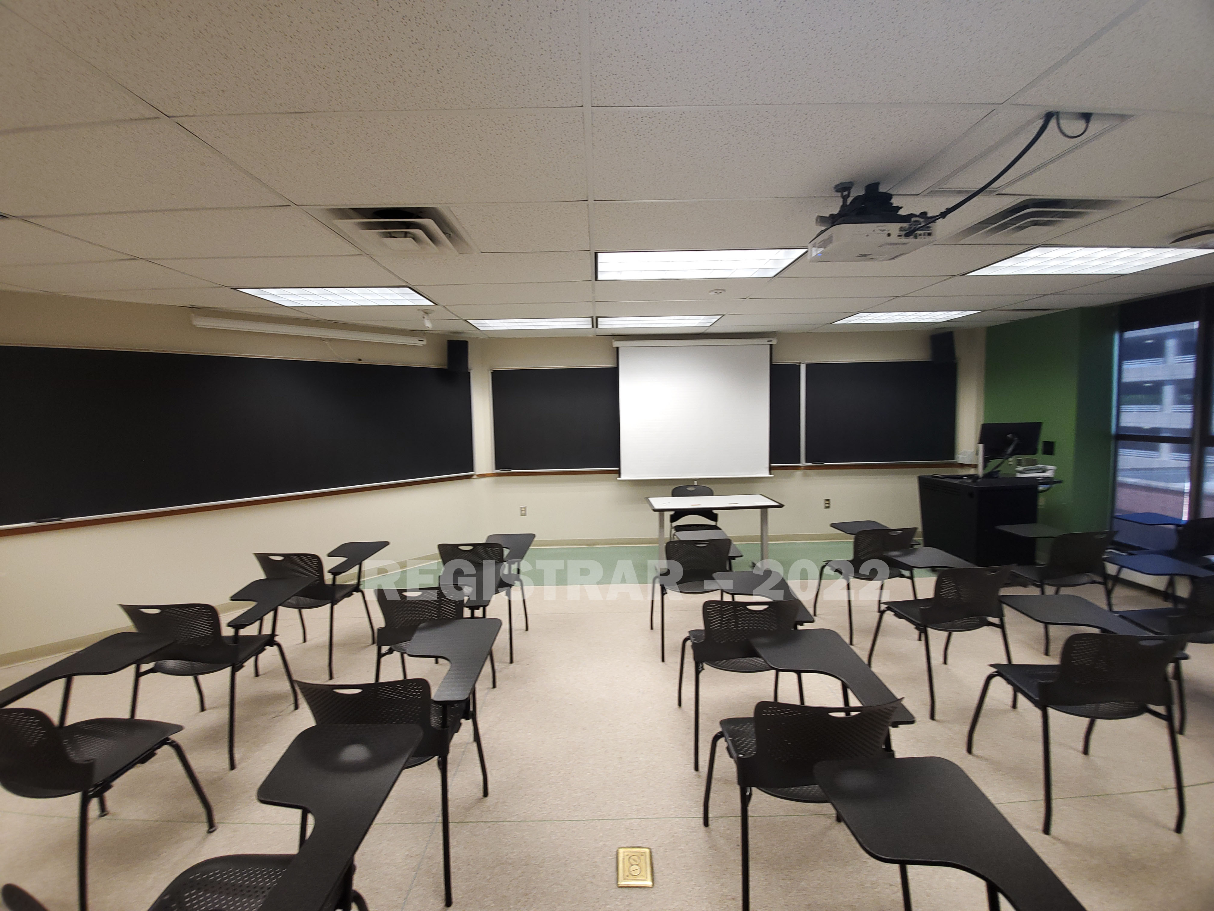 Enarson Classroom Building room 330 ultra wide angle view from the back of the room with projector screen down