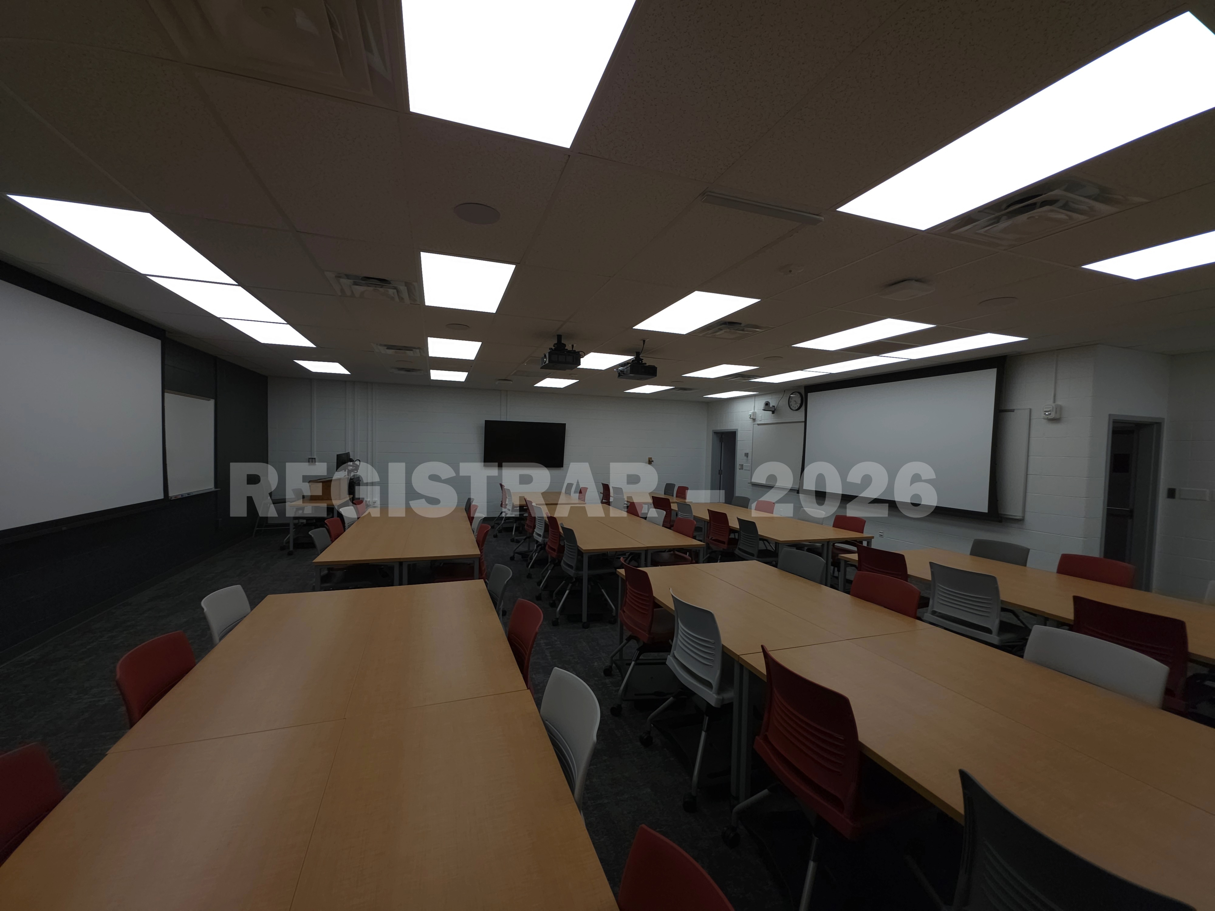 University Hall room 86 ultra wide angle view from the back of the room with projector screen down