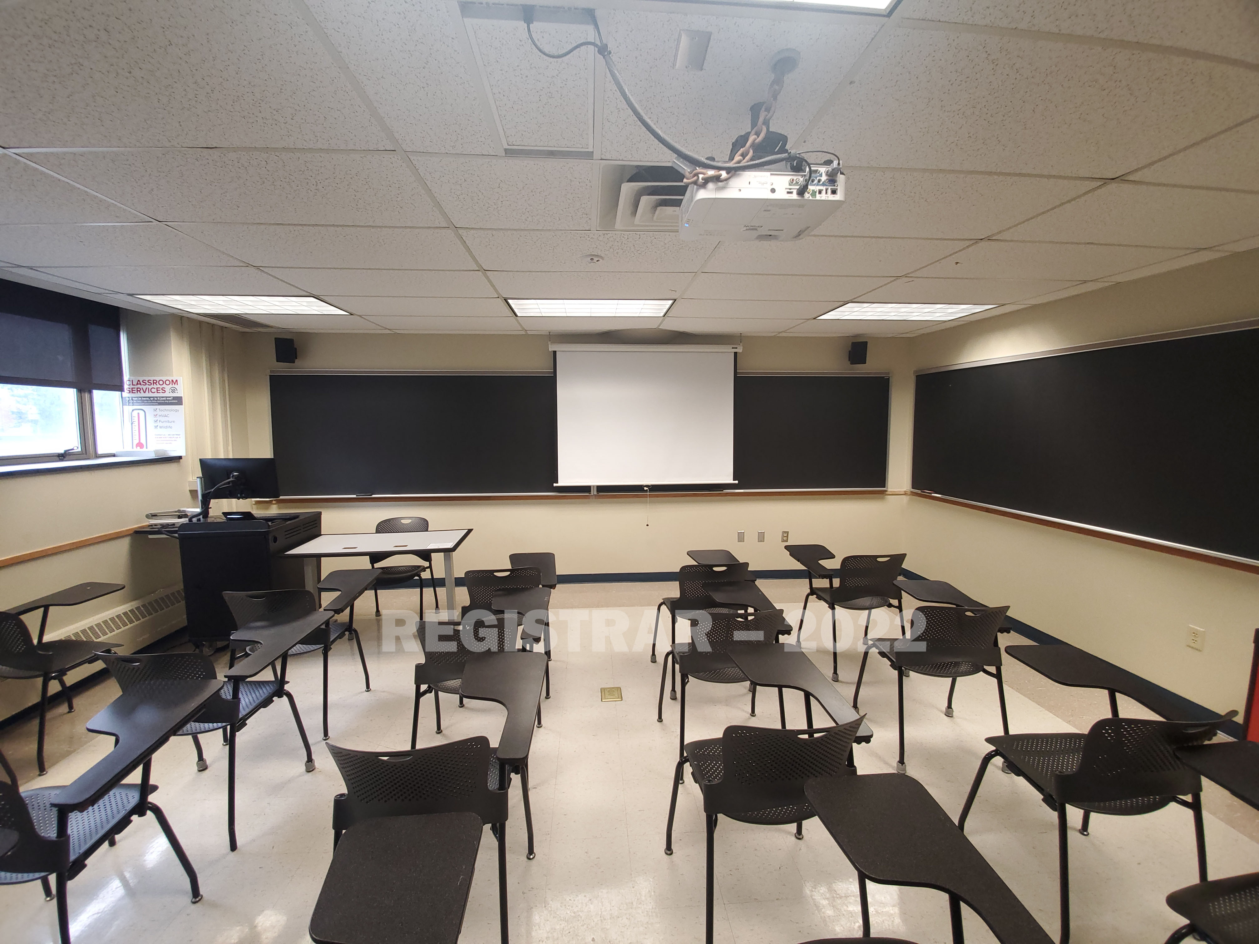 Enarson Classroom Building room 212 ultra wide angle view from the back of the room with projector screen down