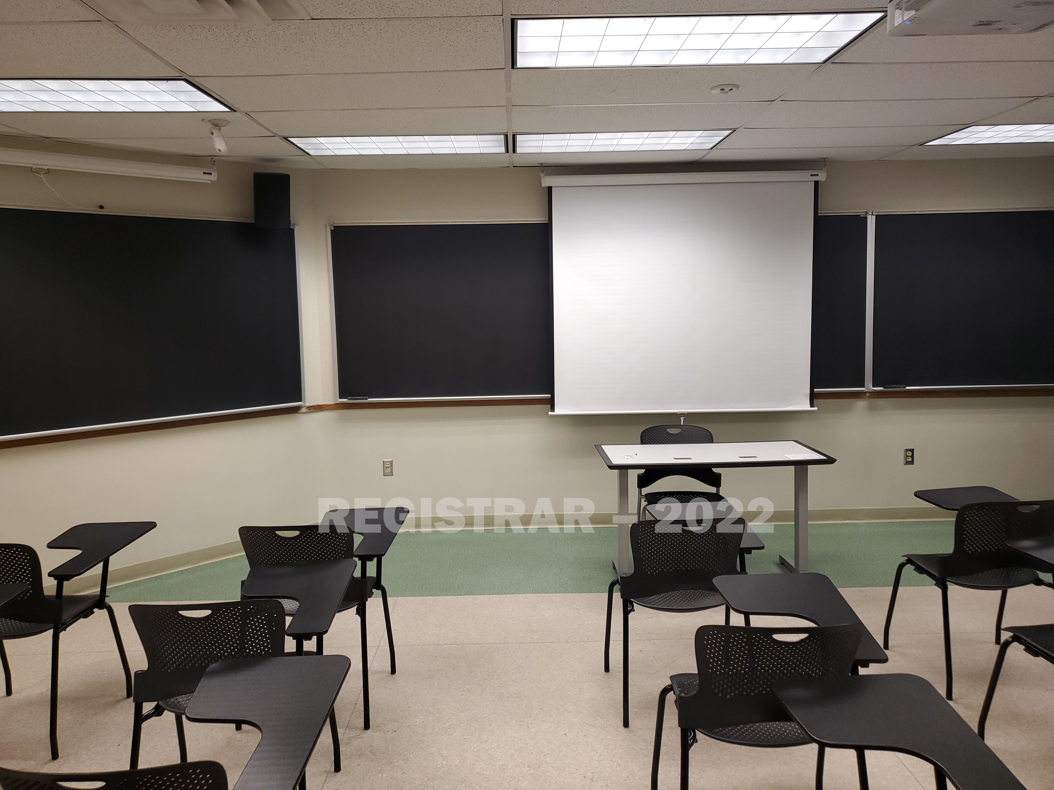 Enarson Classroom Building room 330 view from the back of the room with projector screen down
