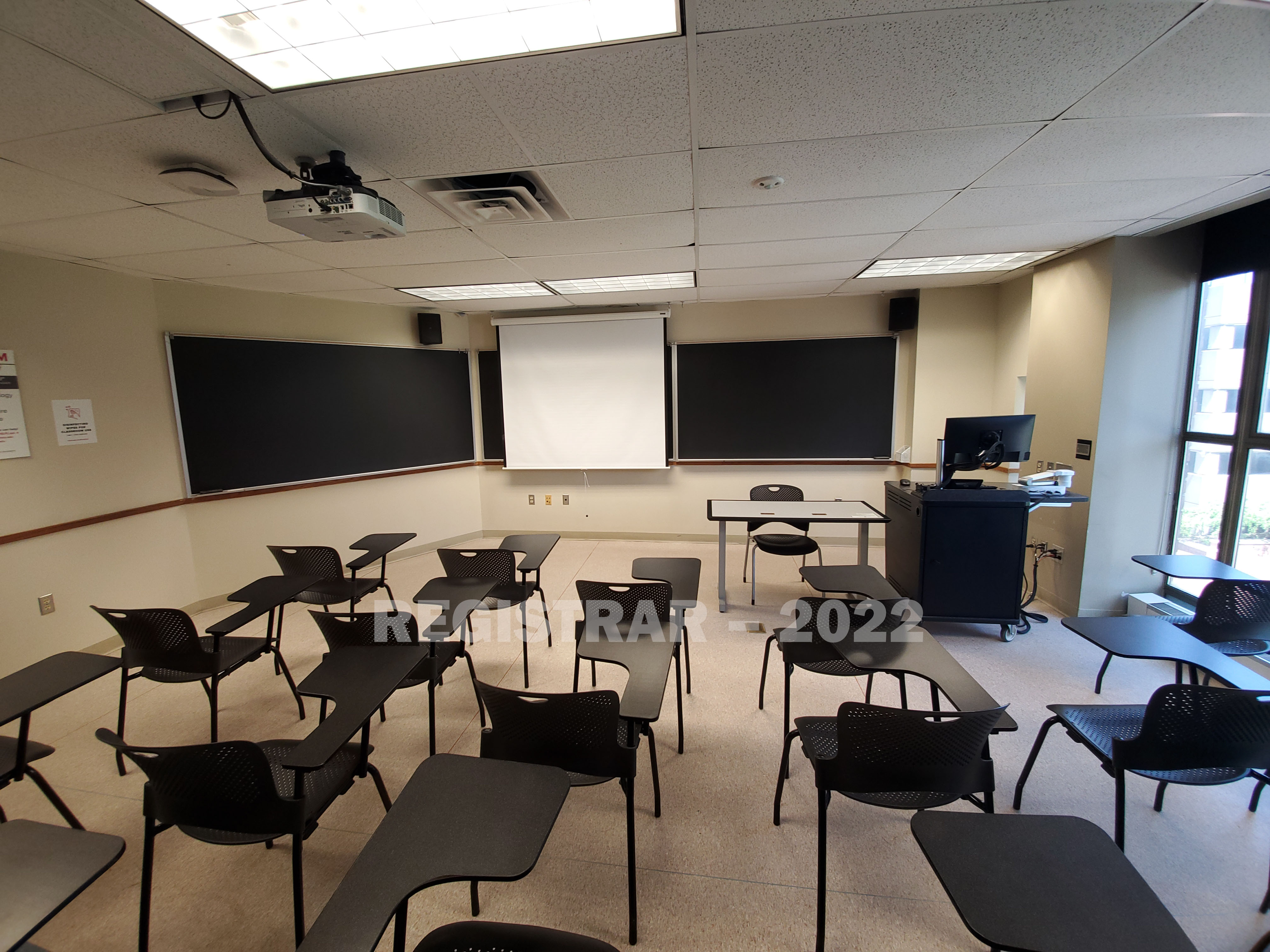 Enarson Classroom Building room 318 ultra wide angle view from the back of the room with projector screen down