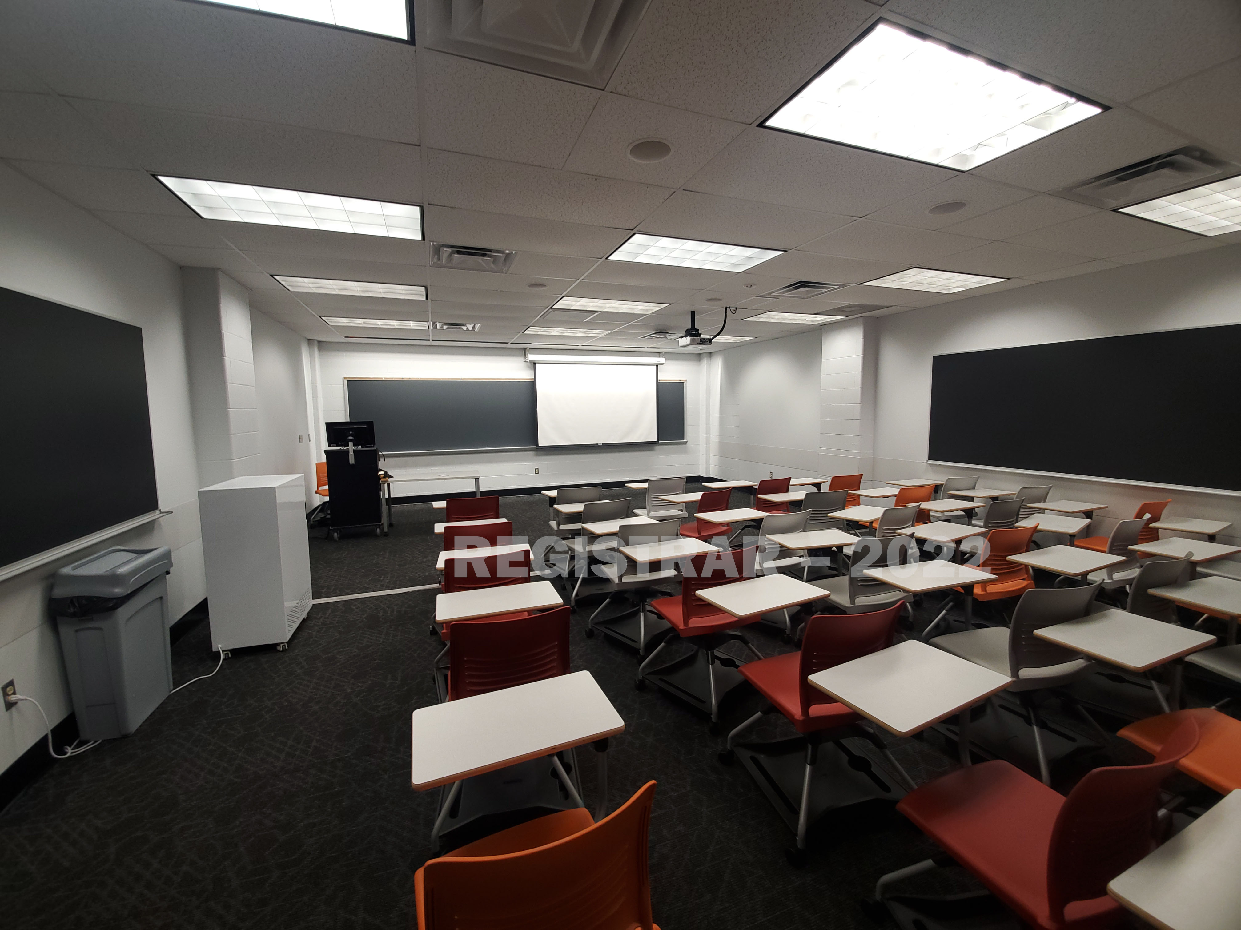Journalism Building room 375 ultra wide angle view from the back of the room with projector screen down