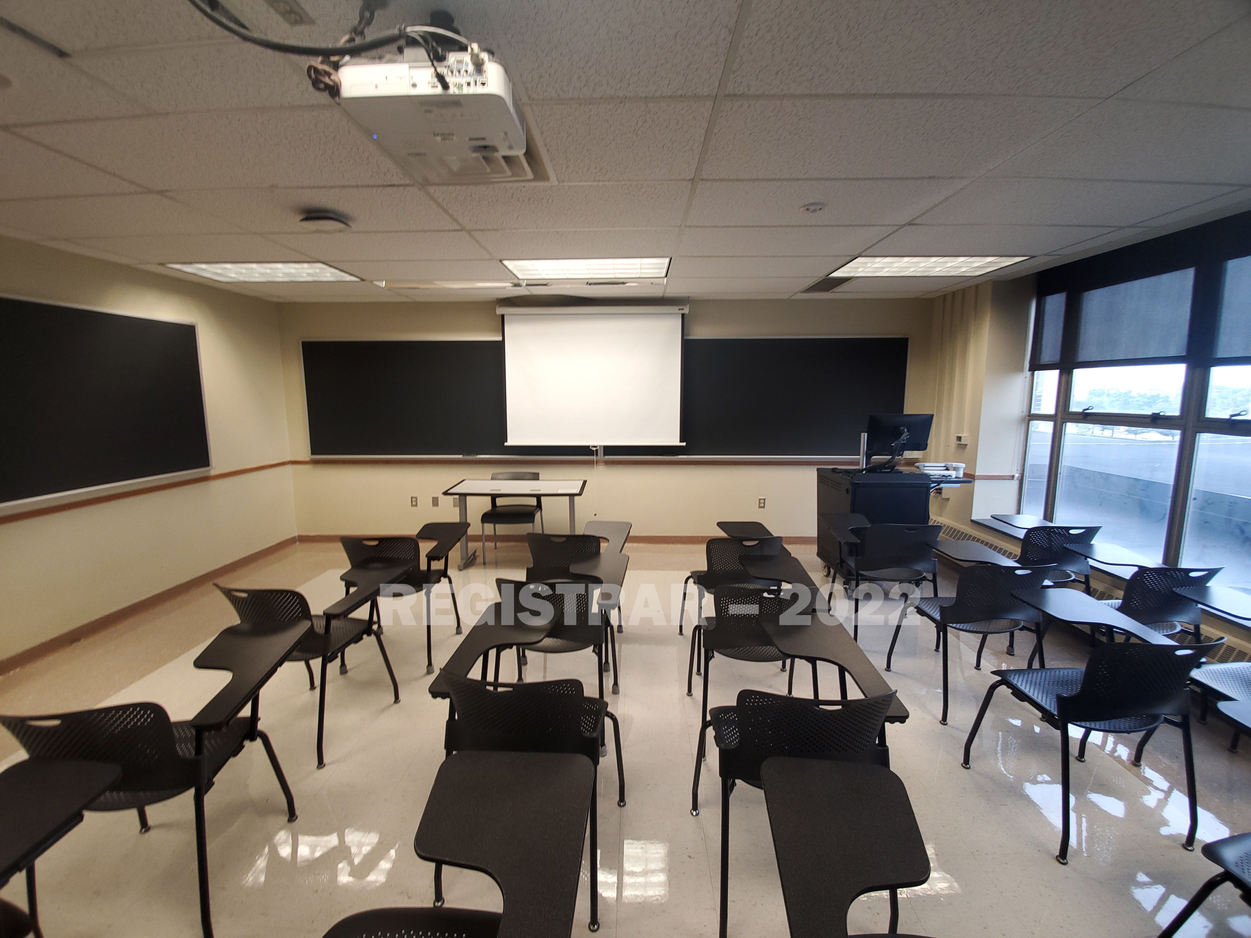 Enarson Classroom Building room 240 ultra wide angle view from the back of the room with projector screen down