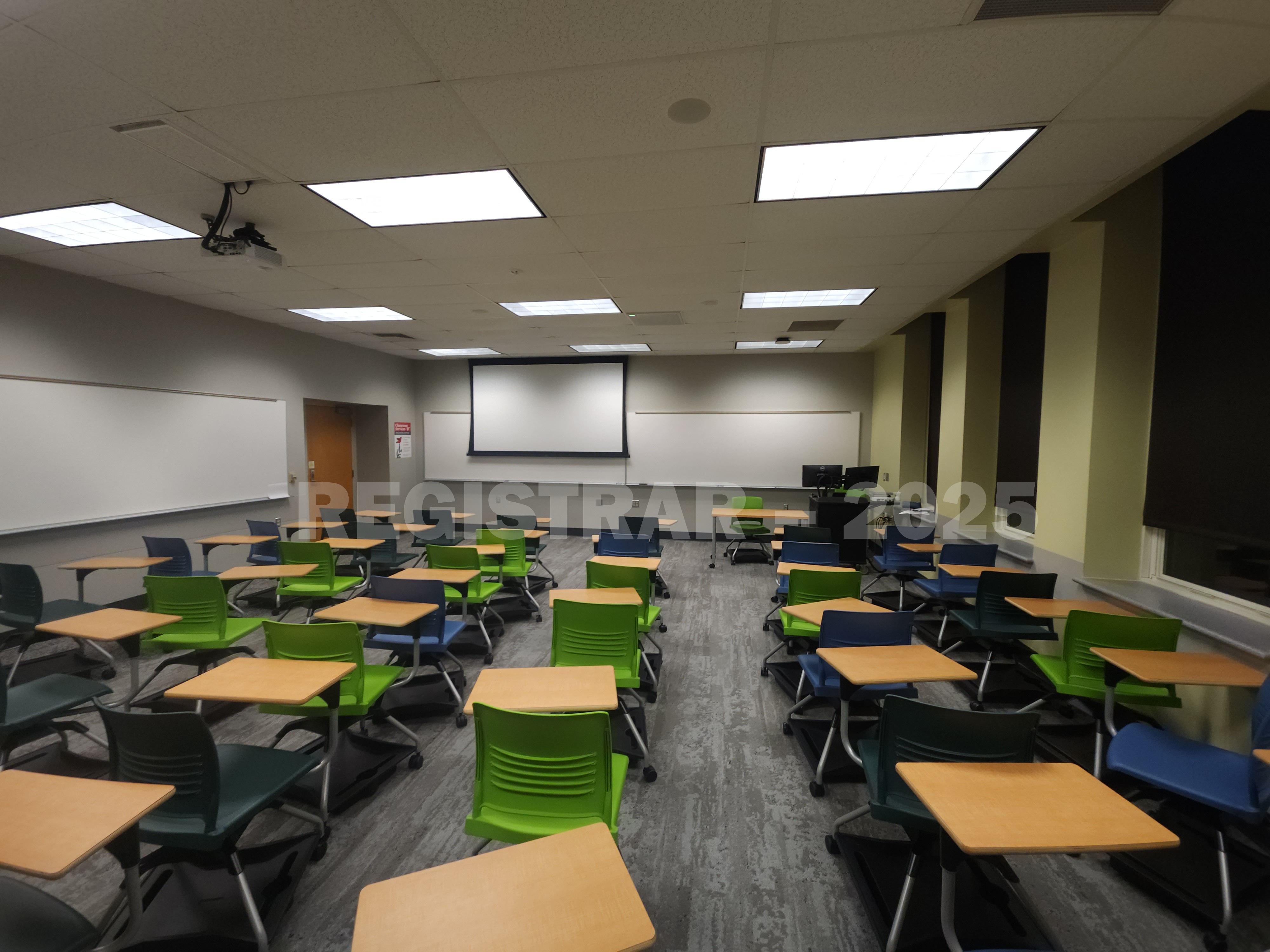 Mendenhall Laboratory room 185  view from the back of the room with projector screen down