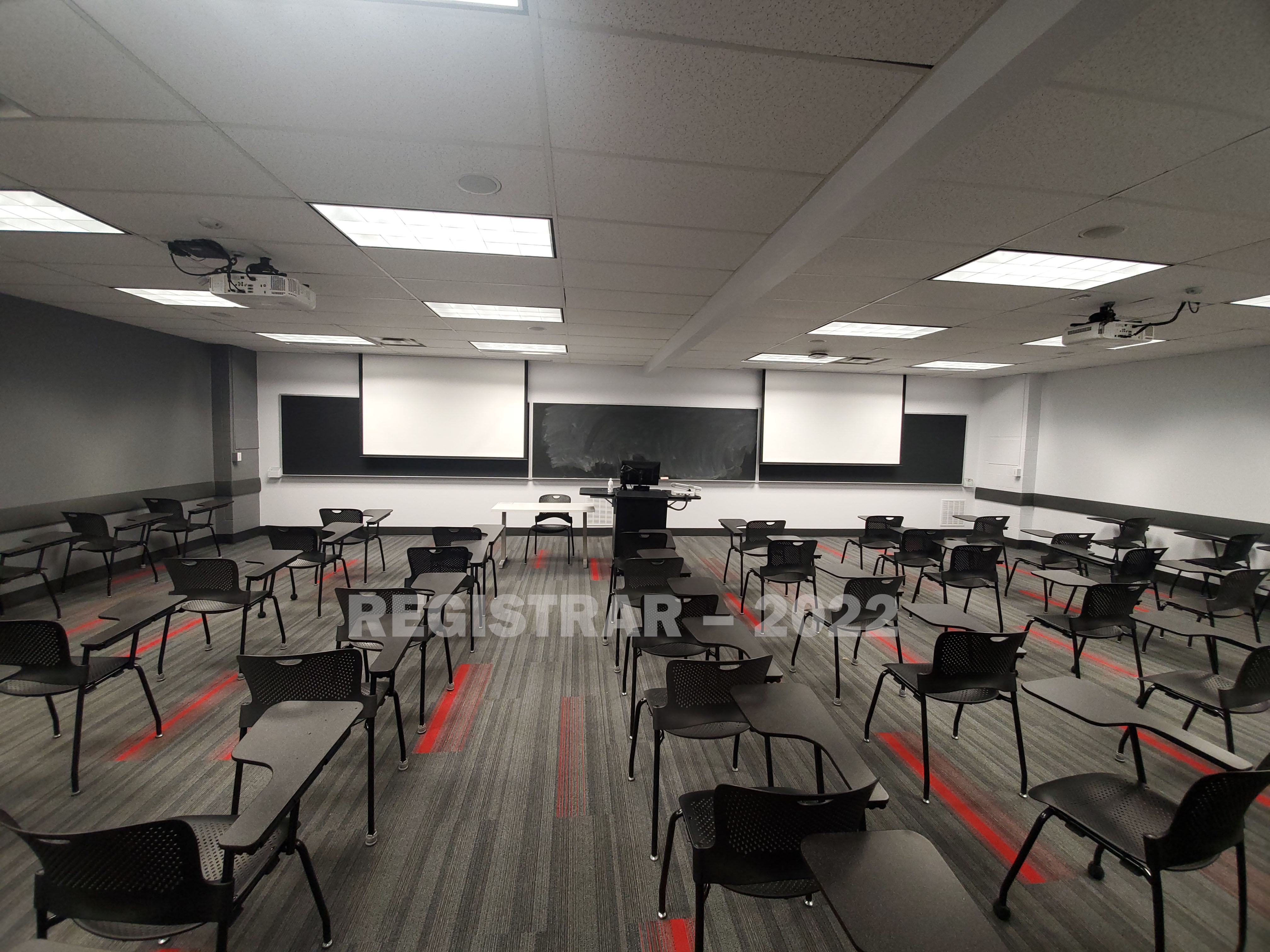 Baker Systems Engineering room 188 ultra wide angle view from the back of the room with projector screen down