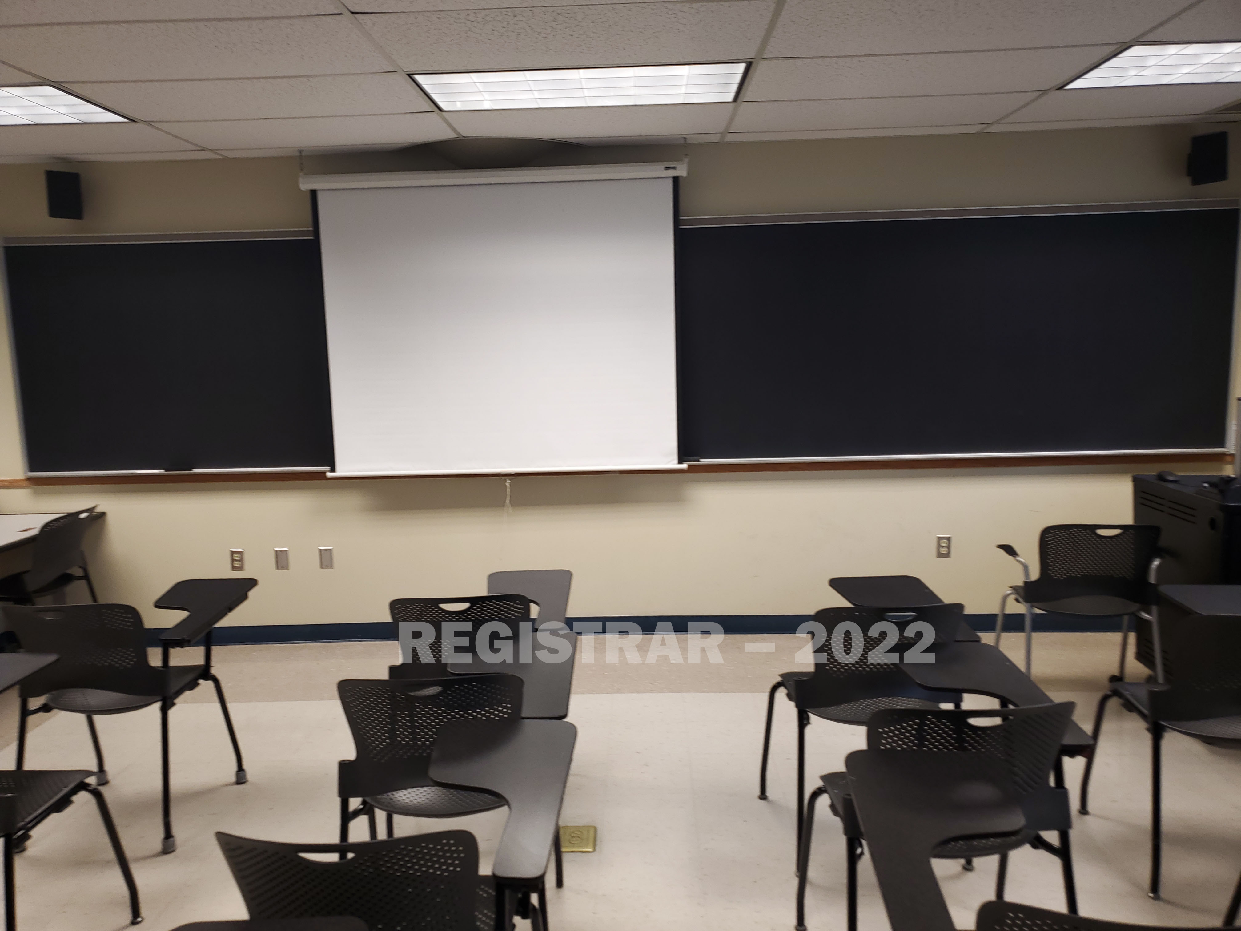 Enarson Classroom Building room 206 view from the back of the room with projector screen down