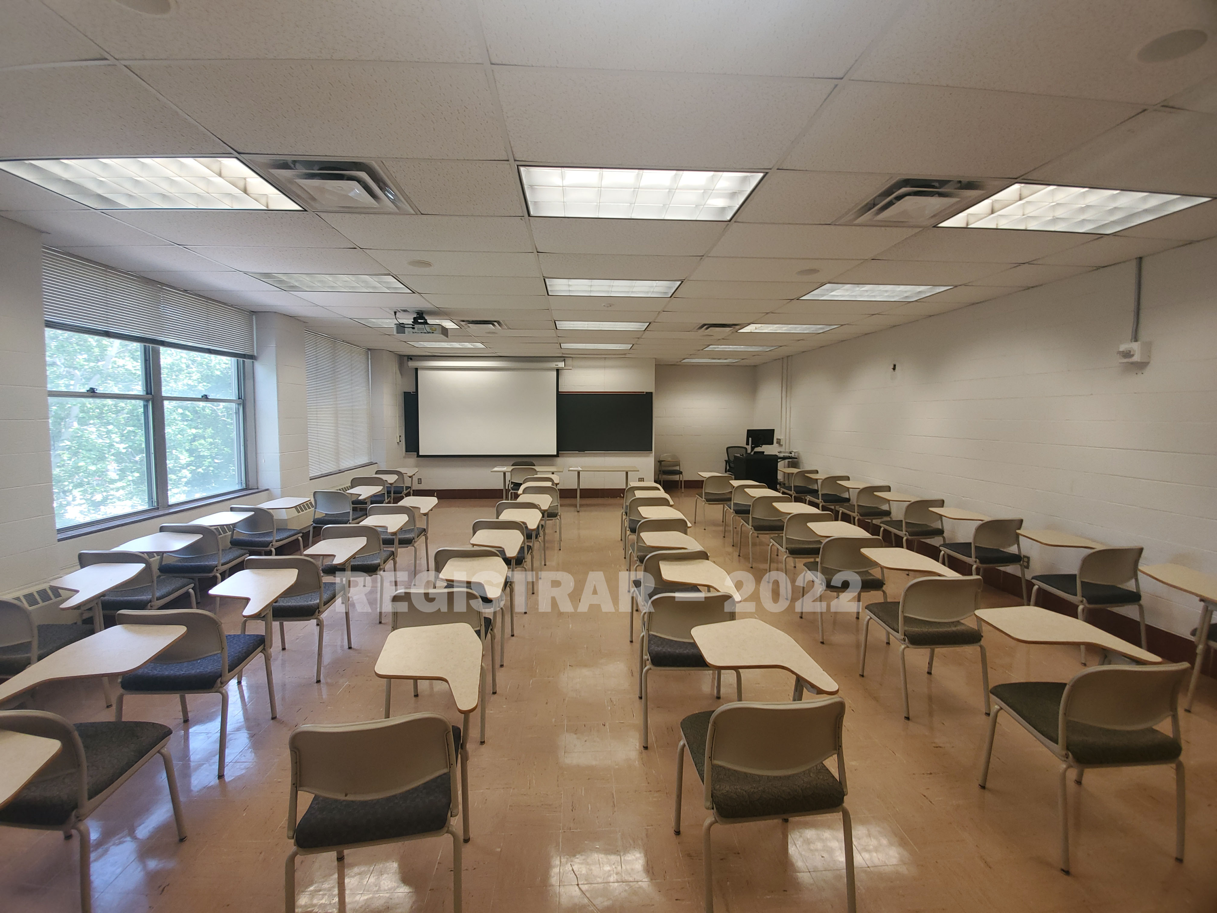 Animal Science Building room 202 ultra wide angle view from the back of the room with projector screen down