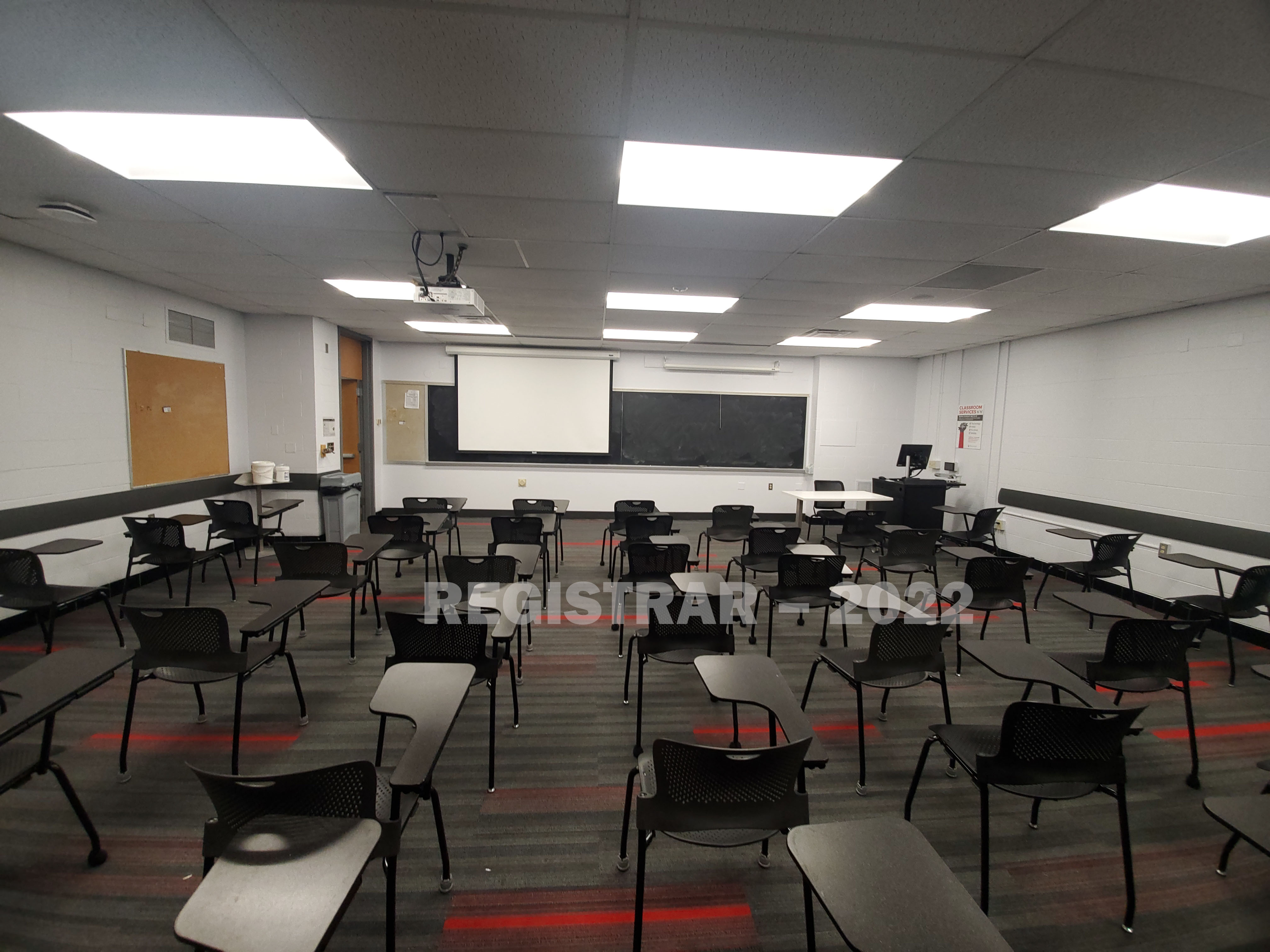 Baker Systems Engineering room 198 ultra wide angle view from the back of the room with projector screen down