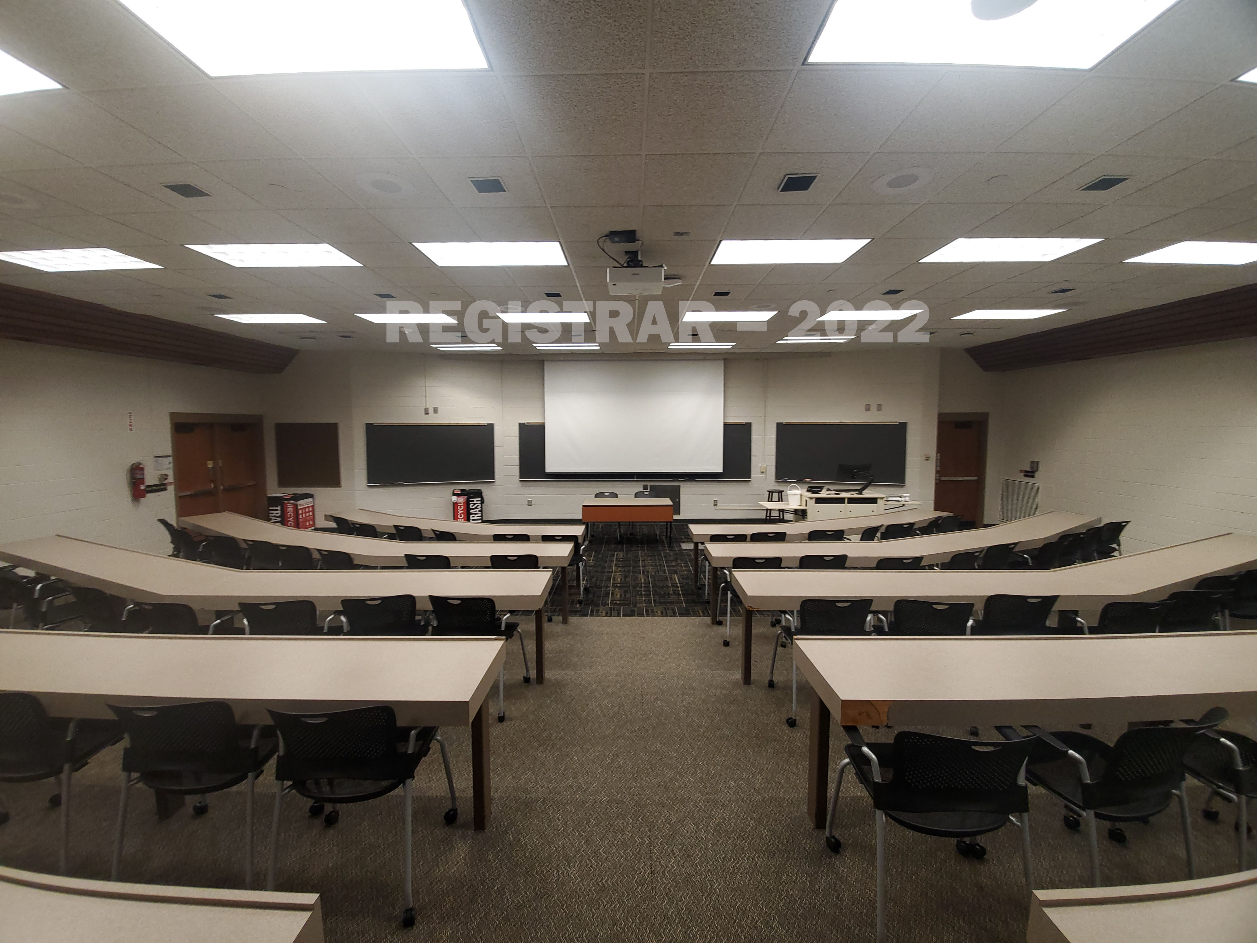 Agricultural Engineering Building room 100 ultra wide angle view from the back of room with projector screen down
