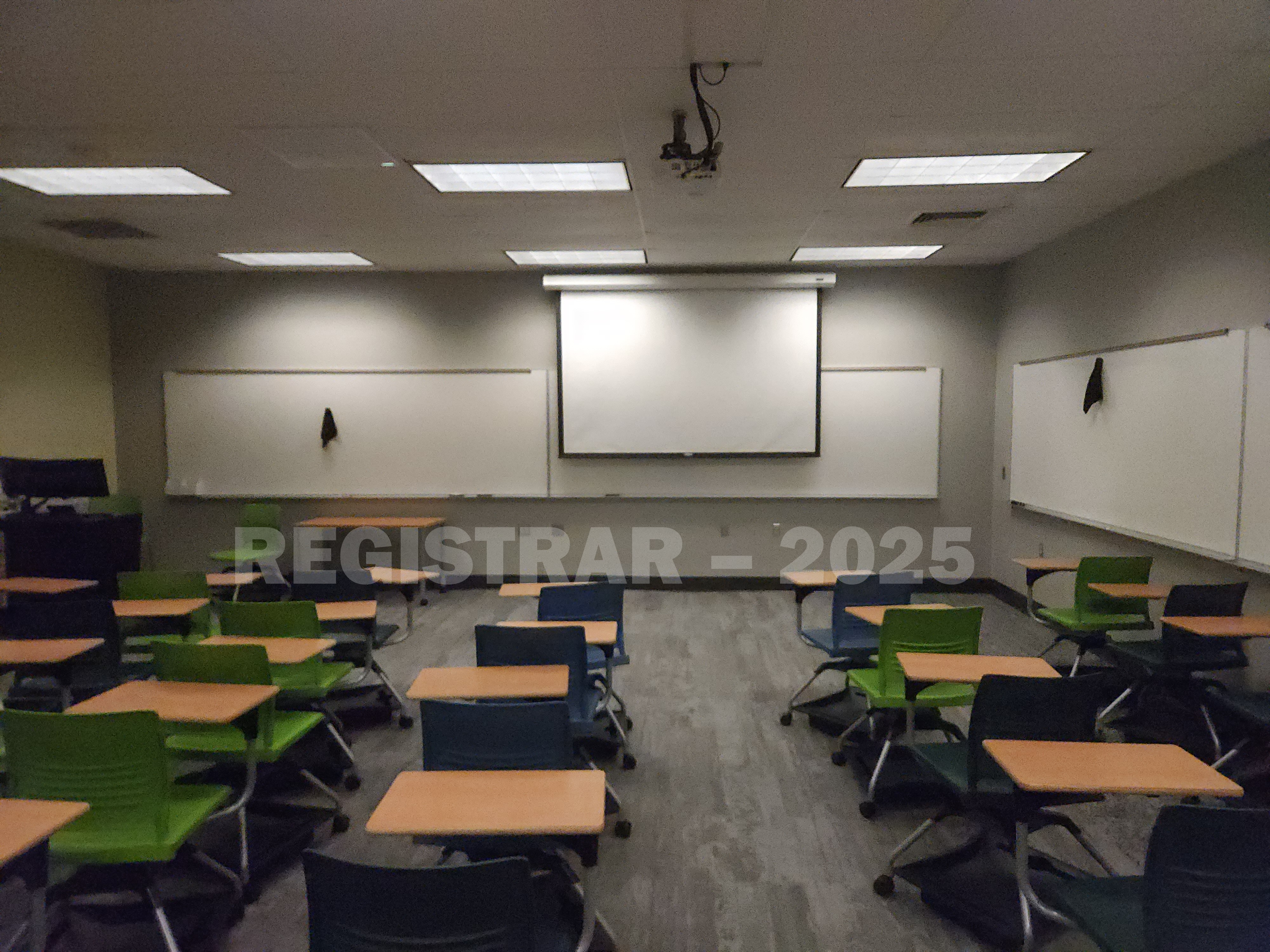 Mendenhall Laboratory room 131  view from the back of the room with projector screen down