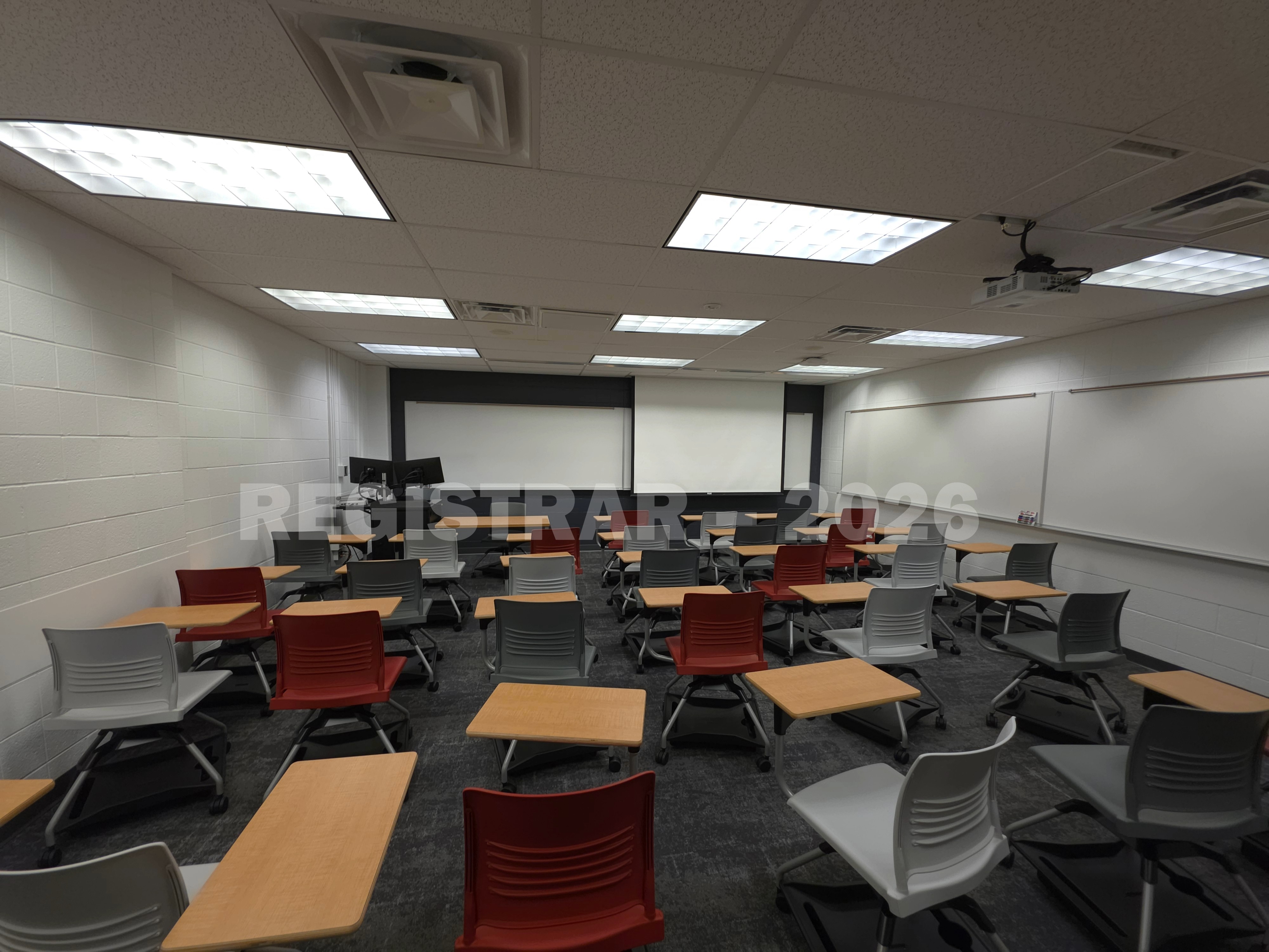 University Hall room 43 ultra wide angle view from the back of the room with projector screen down