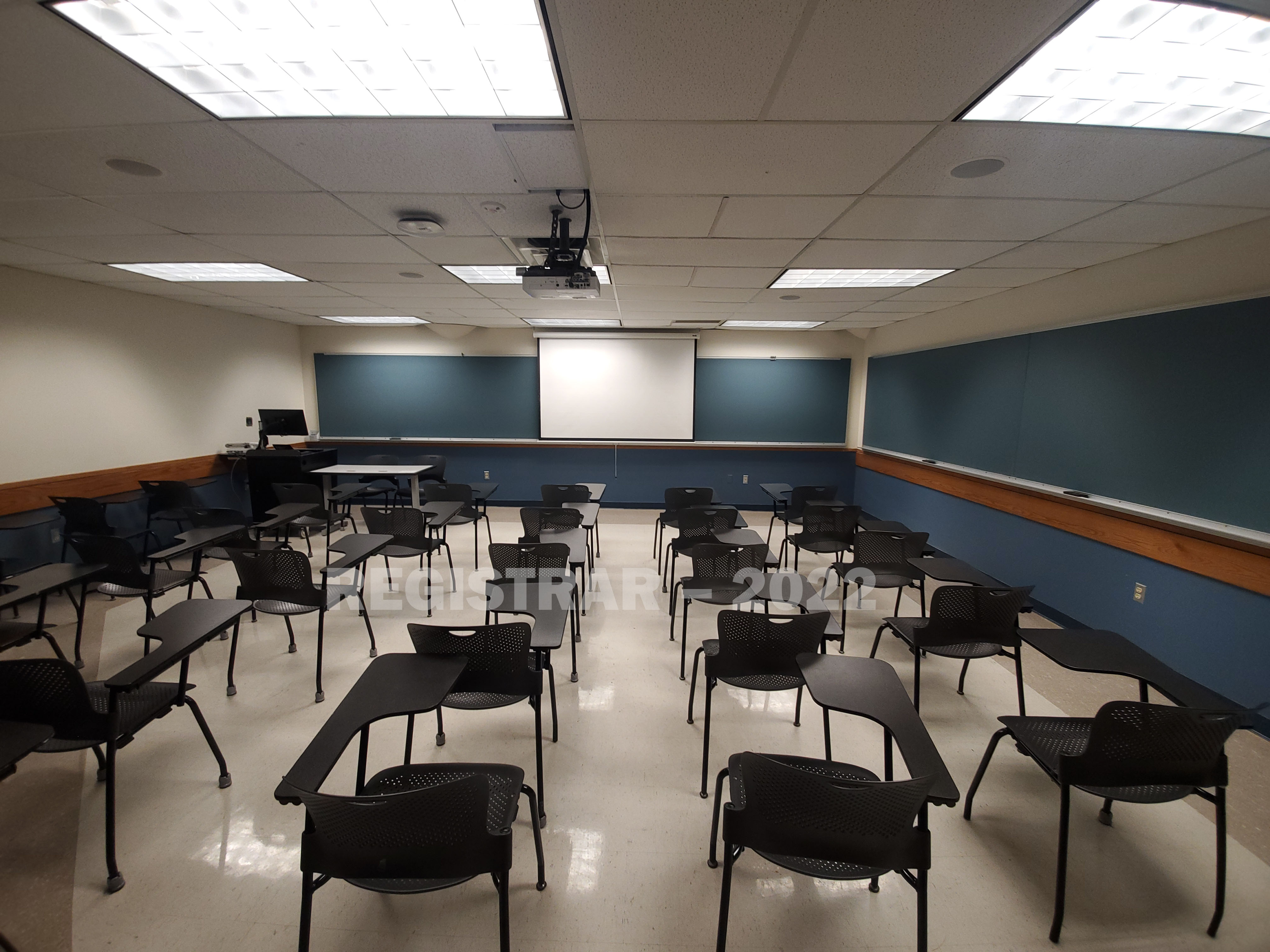 Enarson Classroom Building room 209 ultra wide angle view from the back of the room with projector screen down