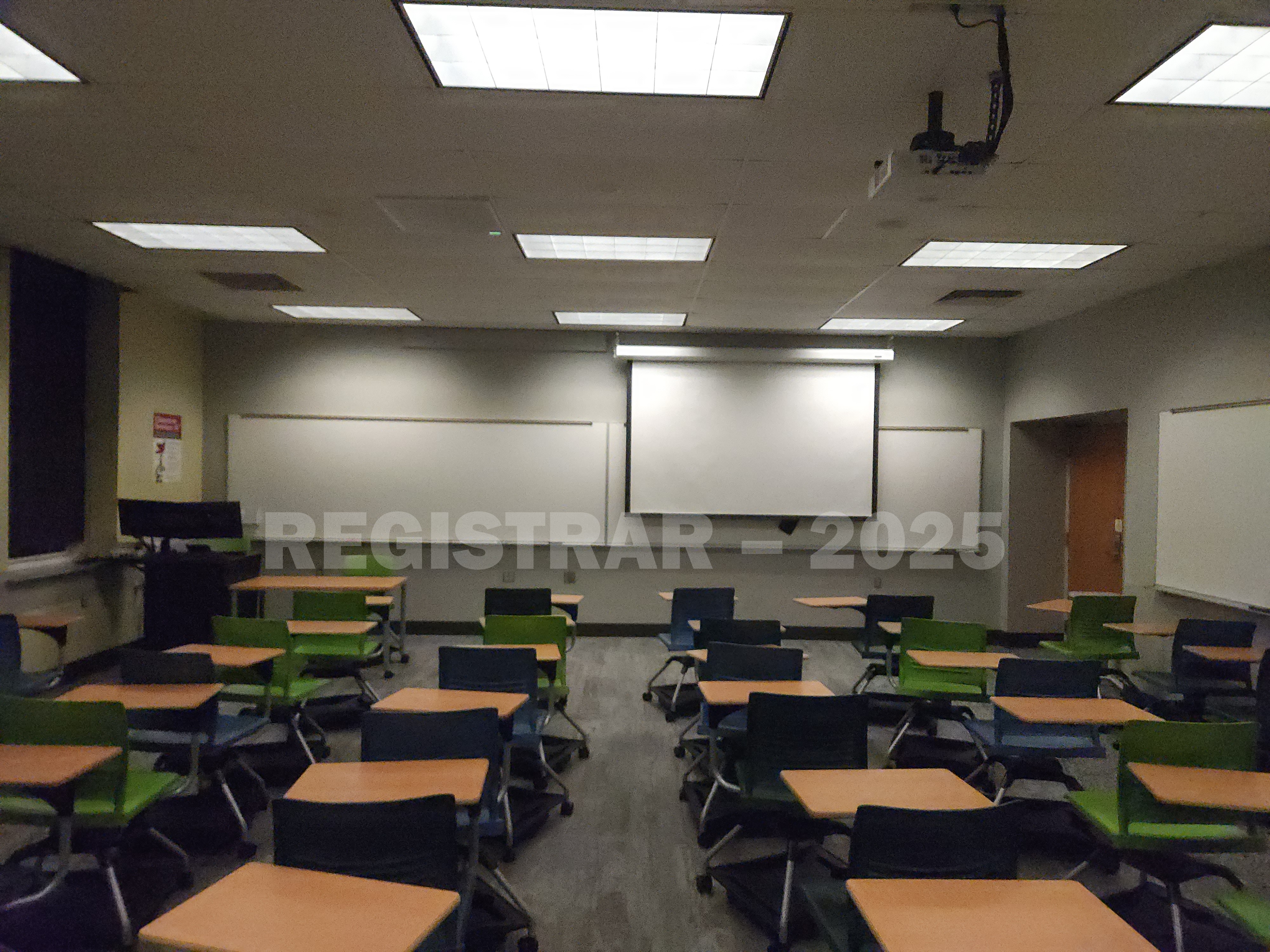 Mendenhall Laboratory room 125  view from the back of the room with projector screen down