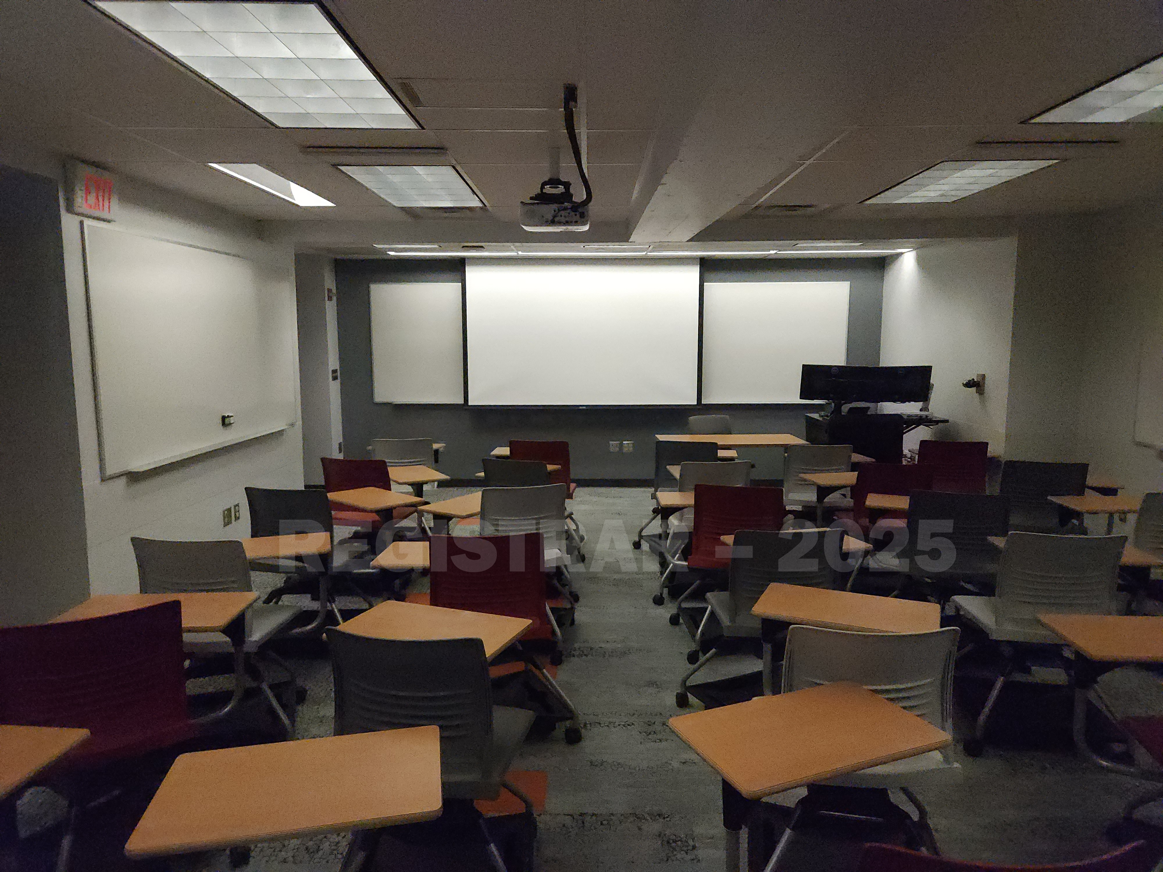 McPherson Chemical Lab room 1008 view from the back of the room with the projector screen down