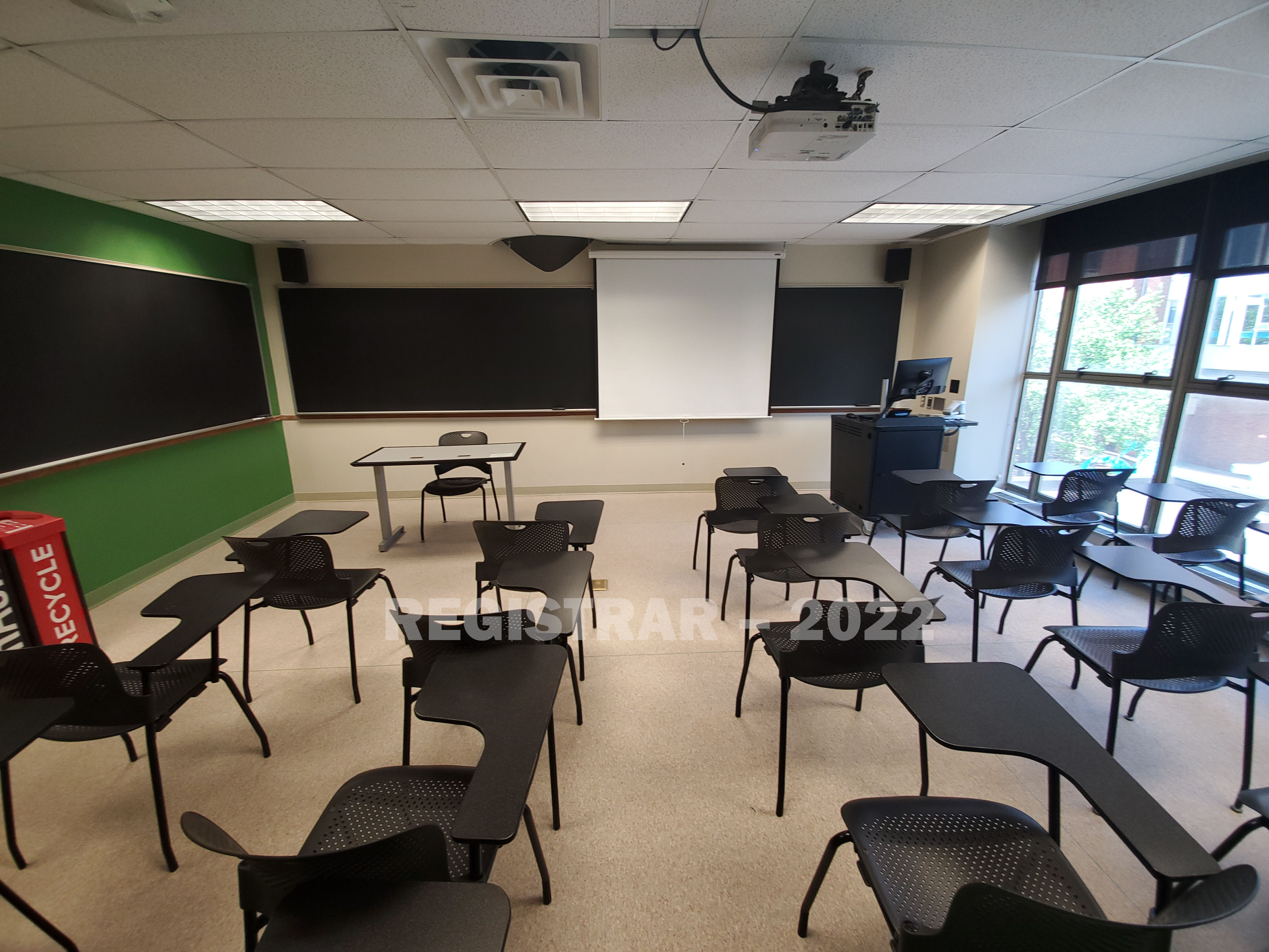 Enarson Classroom Building room 306 ultra wide angle view from the back of the room with projector screen down