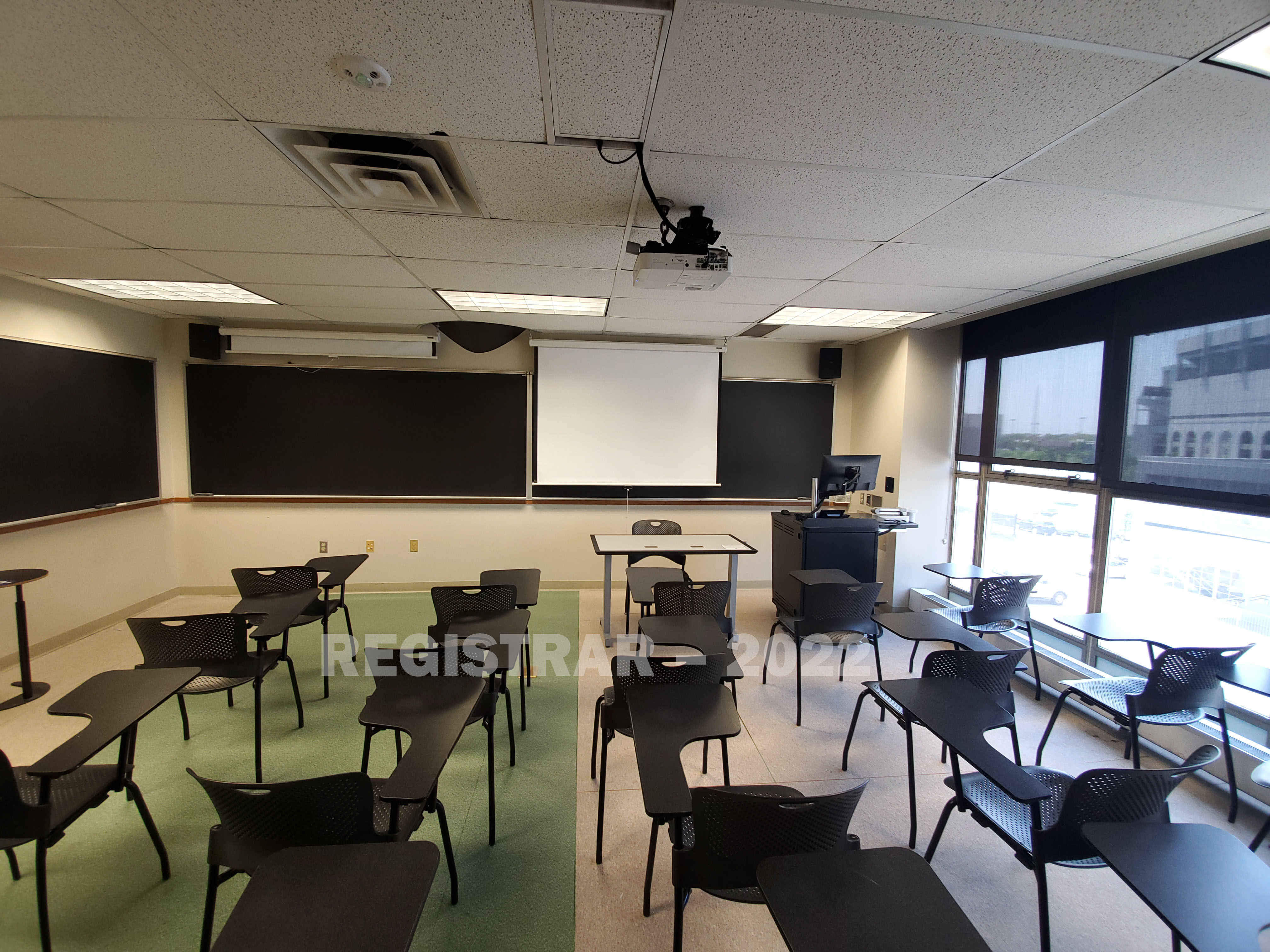 Enarson Classroom Building room 340 ultra wide angle view from the back of the room with projector screen down