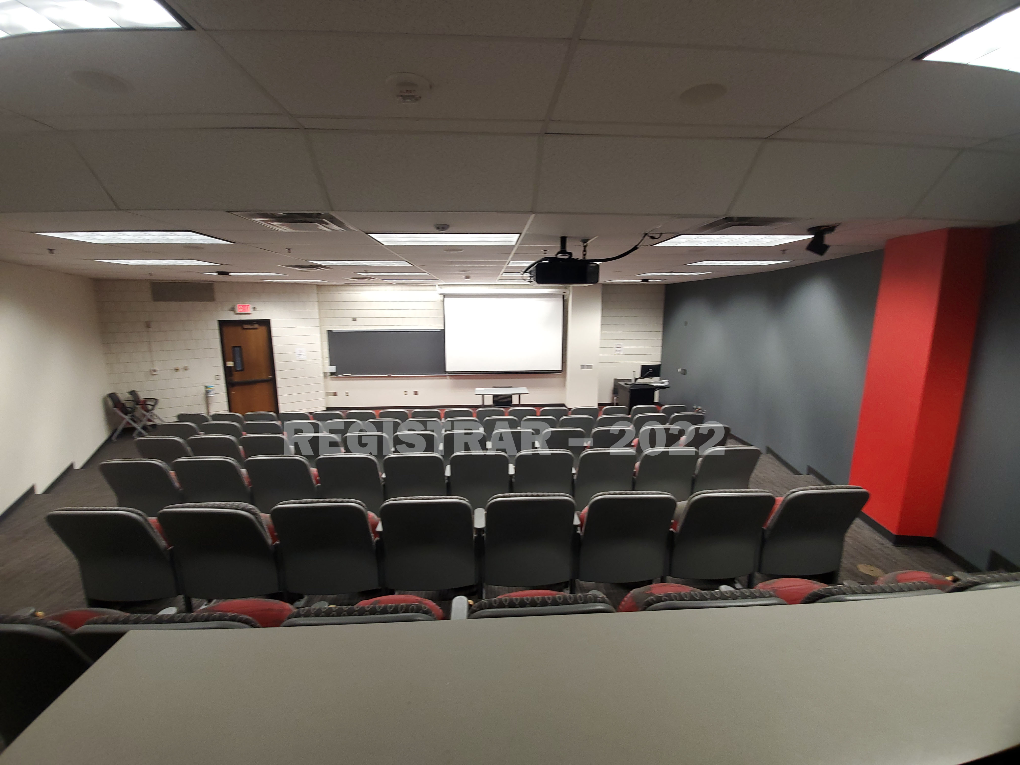 Kottman Hall room 104 ultra wide angle view from the back of the room with projector screen down