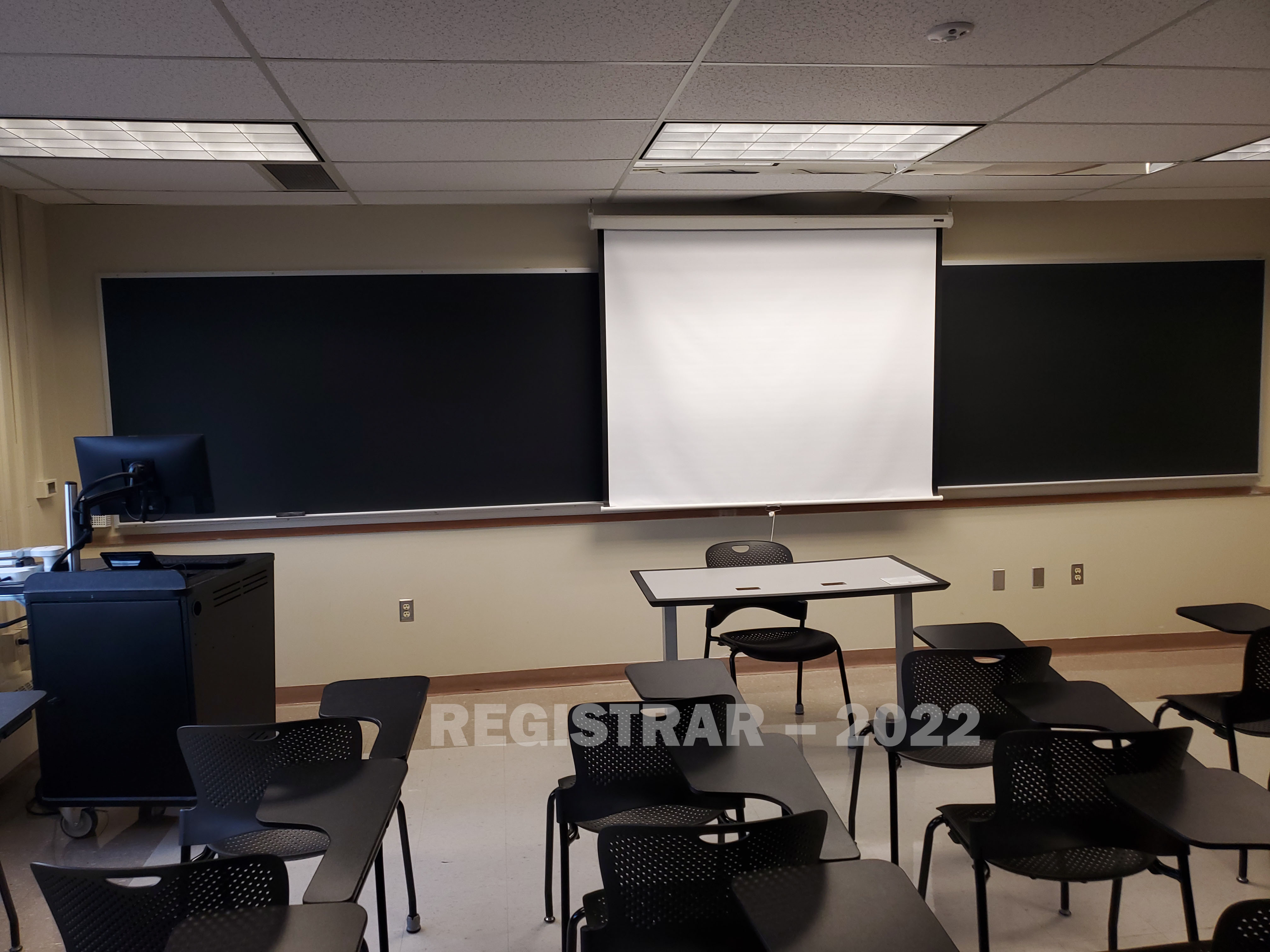 Enarson Classroom Building room 246 view from the back of the room with projector screen down