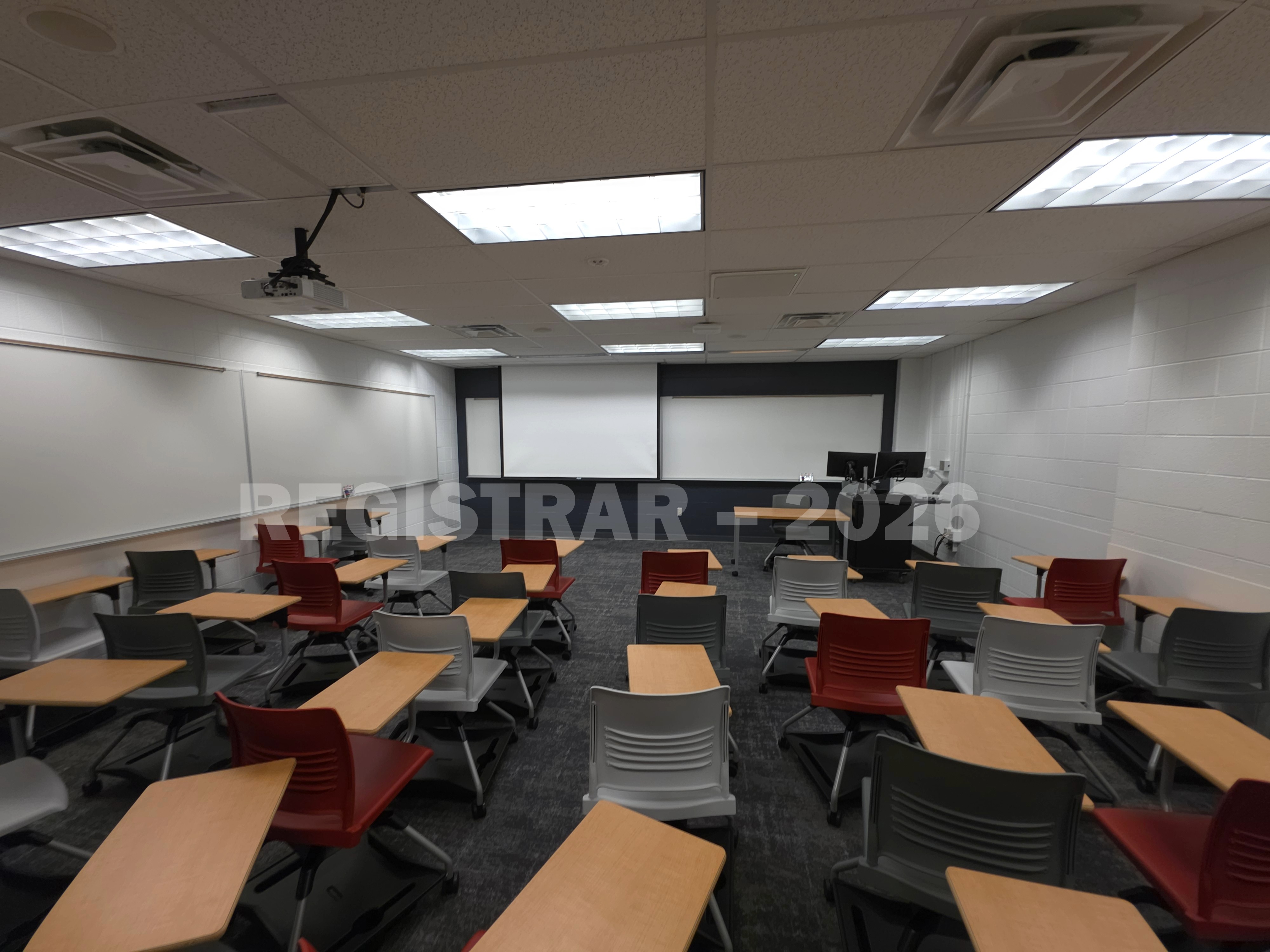 University Hall room 51 ultra wide angle view from the back of the room with projector screen down