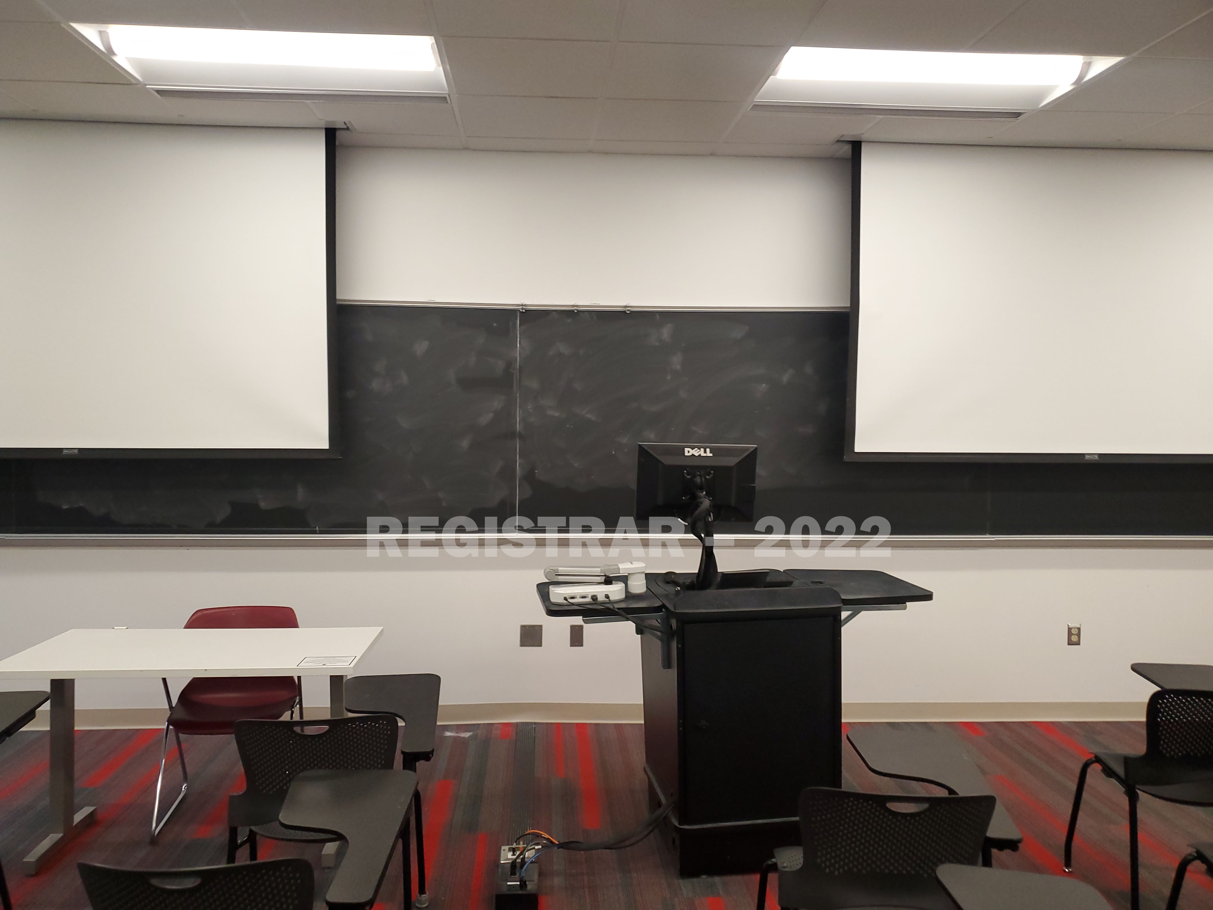 Baker Systems Engineering room 136 view from the back of the room with projector screen down