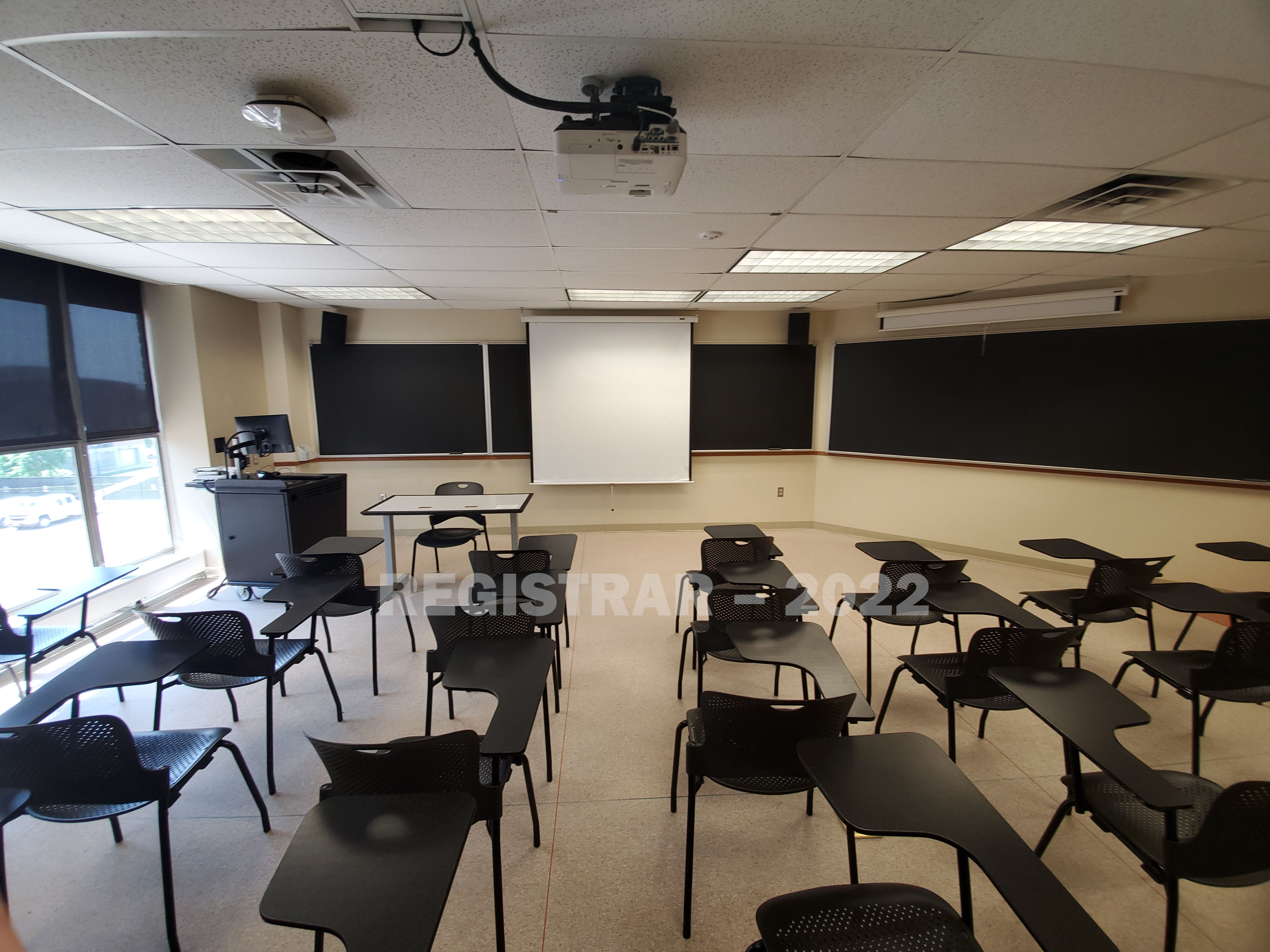 Enarson Classroom Building room 354 ultra wide angle view from the back of the room with projector screen down