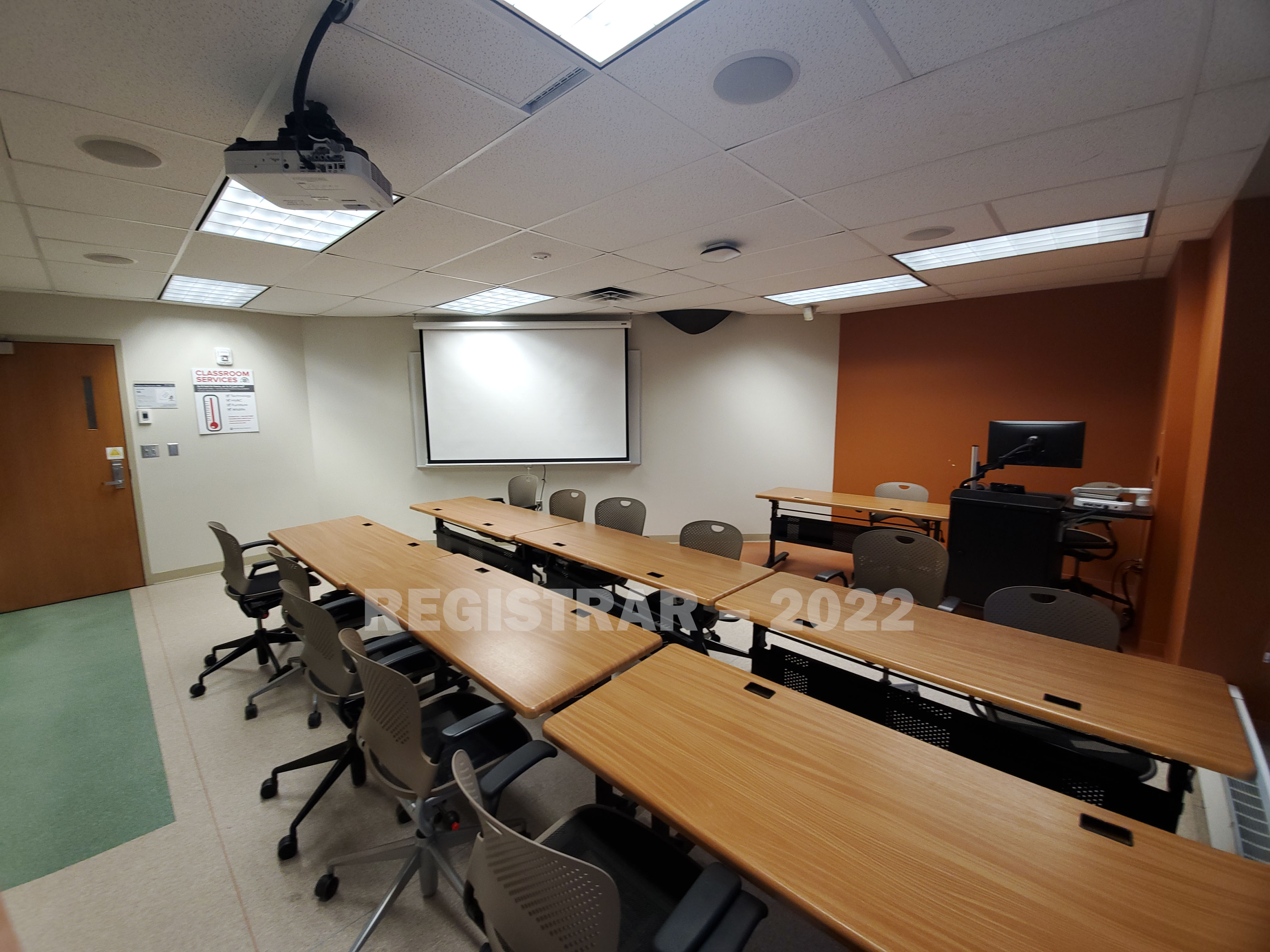 Enarson Classroom Building room 348 ultra wide angle view from the back of the room with projector screen down