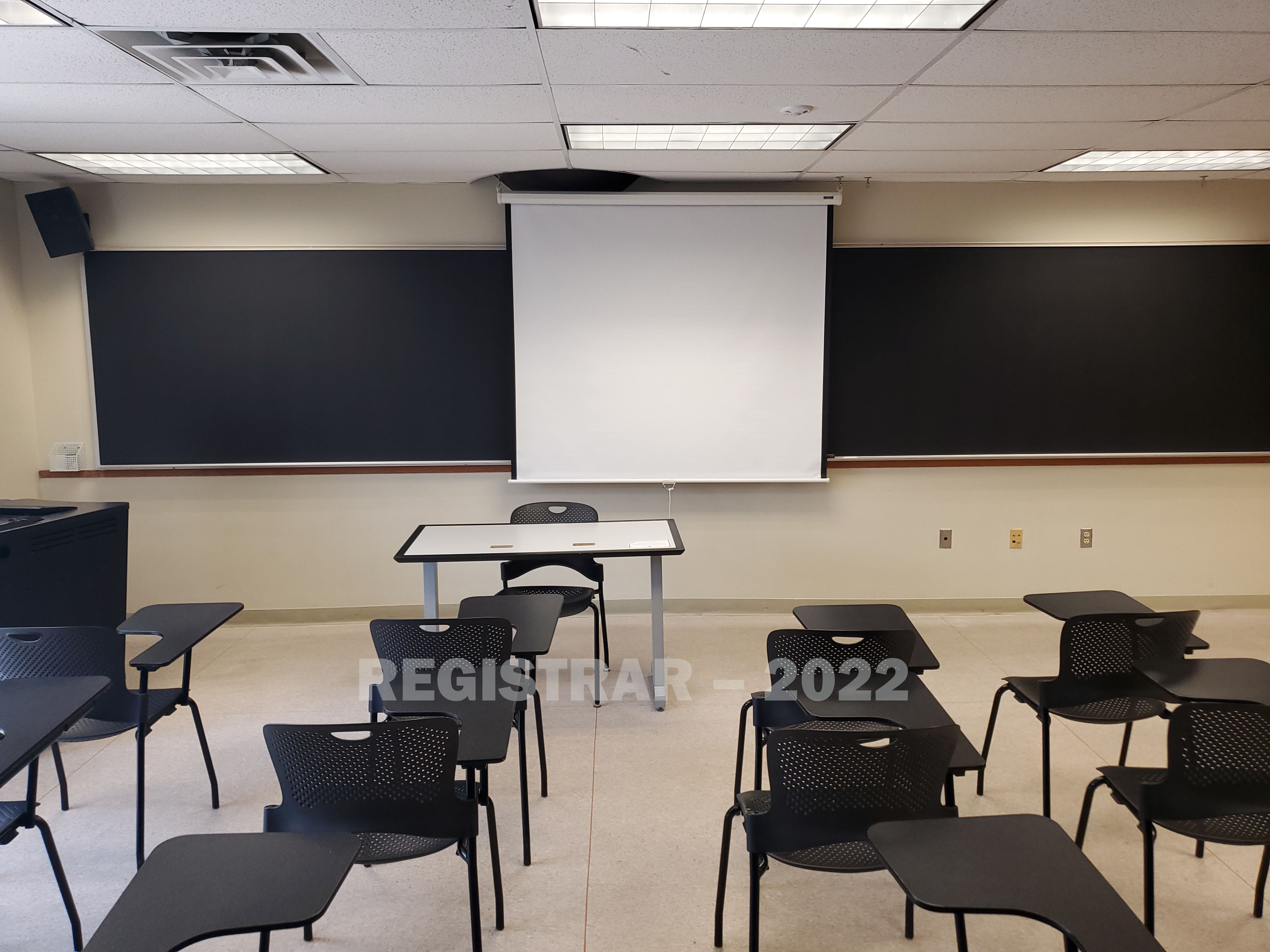 Enarson Classroom Building room 358 view from the back of the room with projector screen down