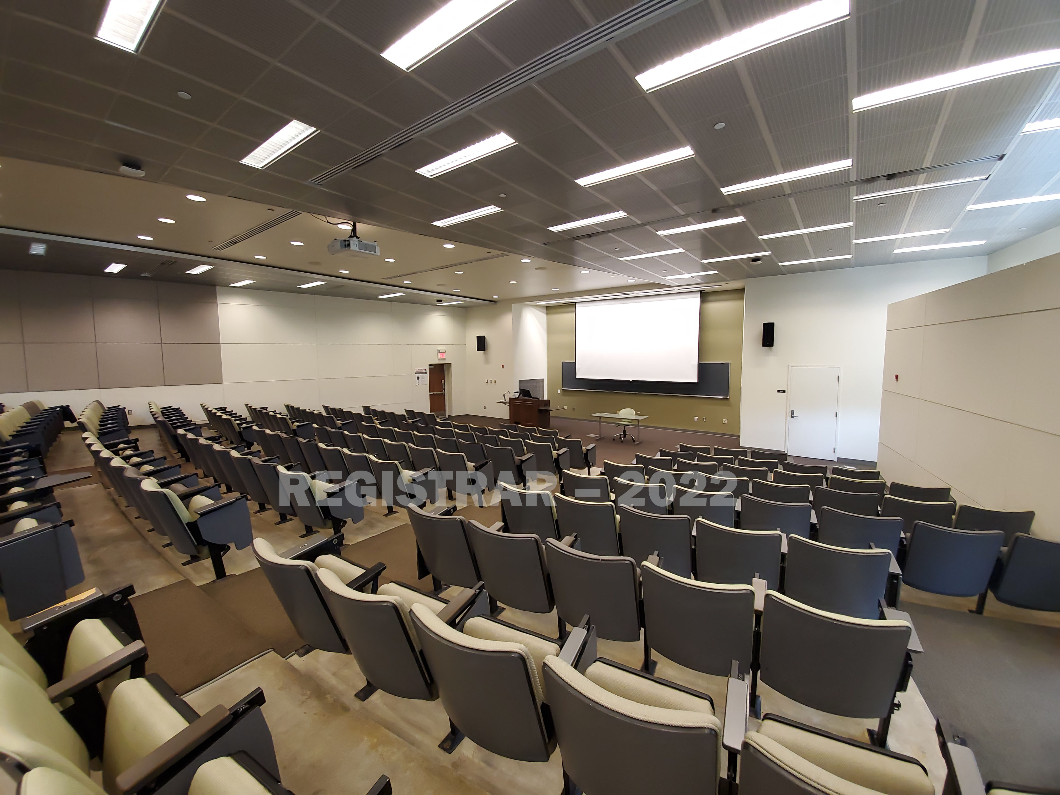 Jennings Hall room 1 ultra wide angle view from the back of the room with projector screen down