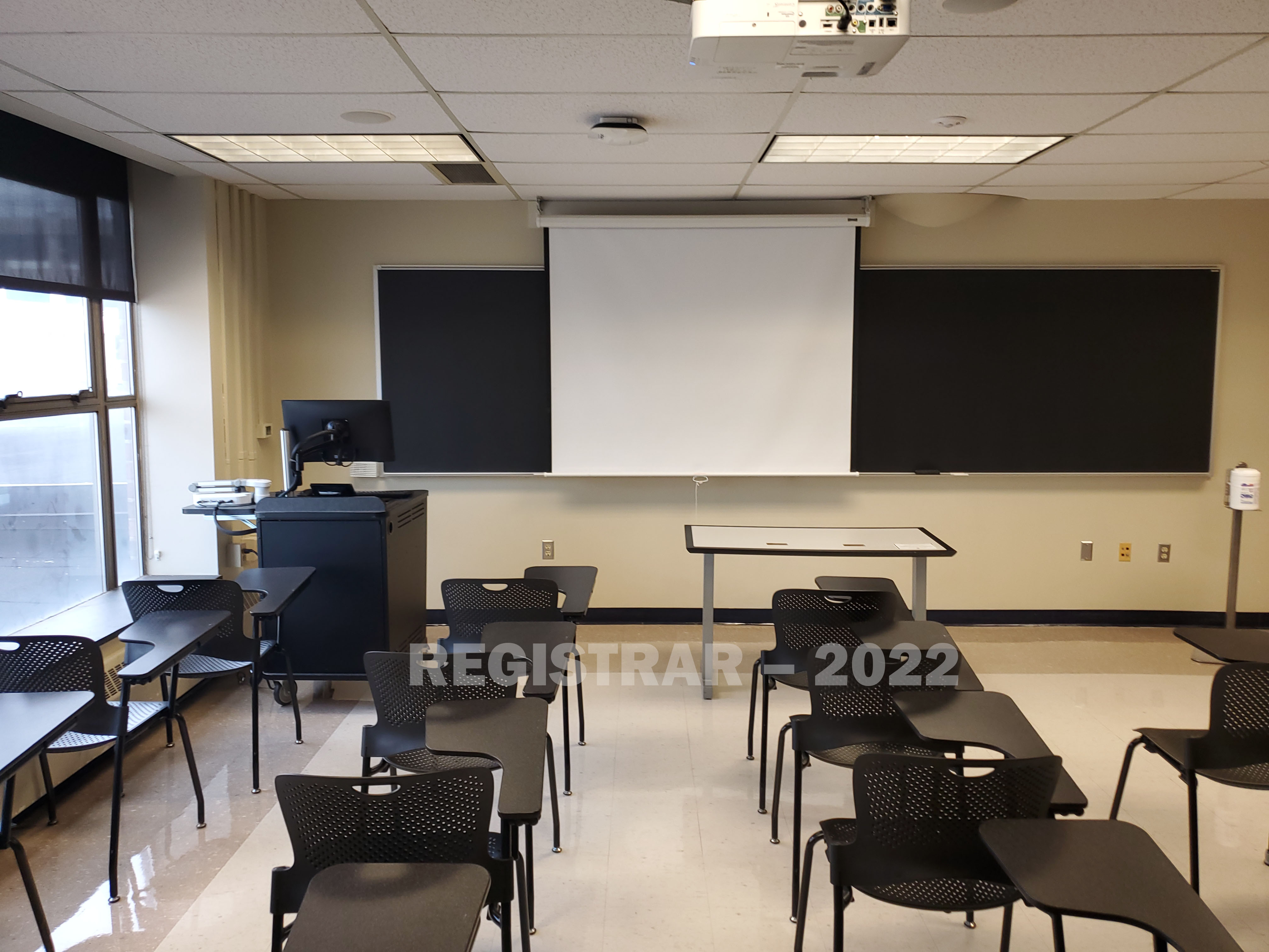 Enarson Classroom Building room 248 view from the back of the room with projector screen down