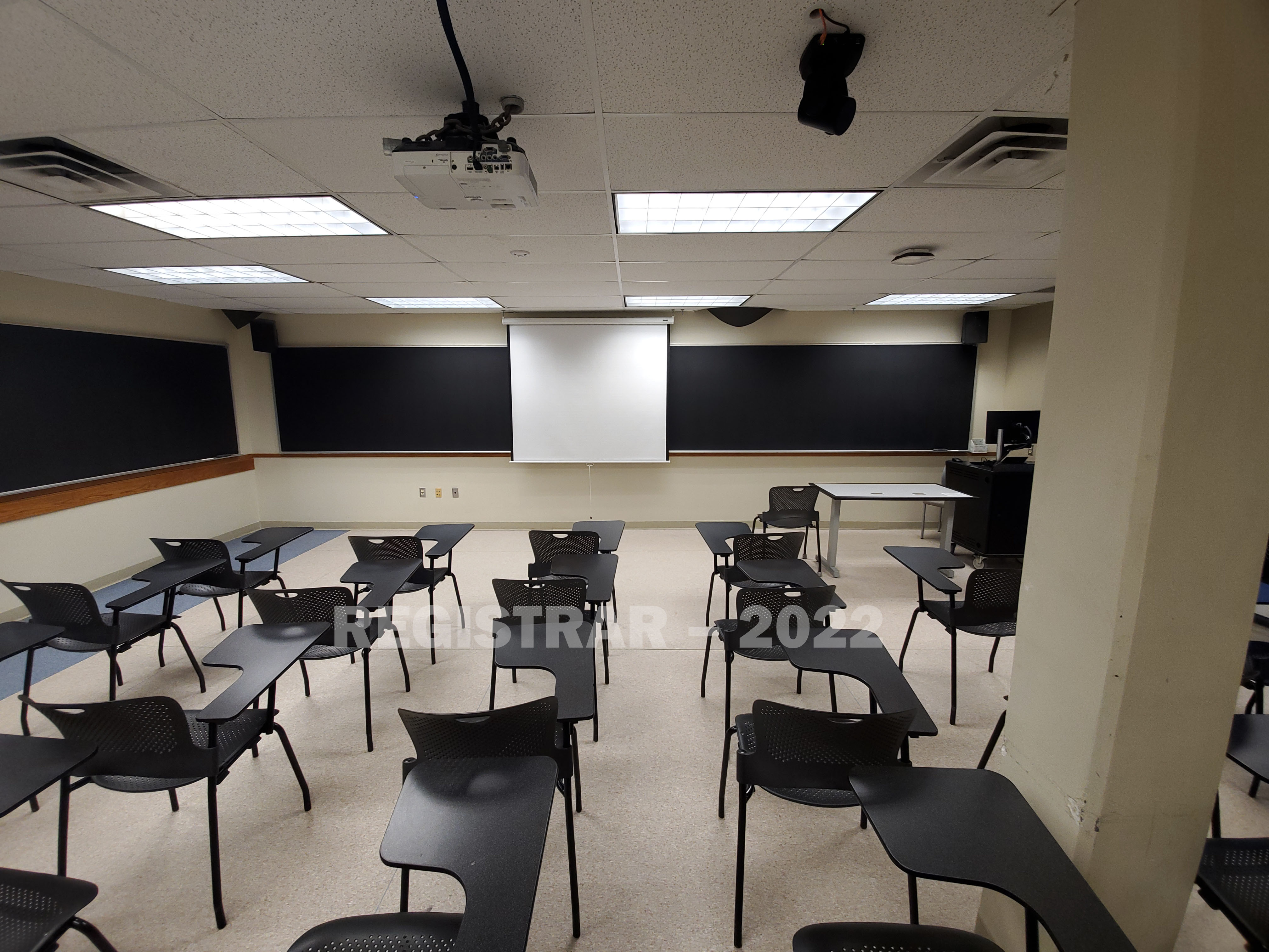 Enarson Classroom Building room 322 ultra wide angle view from the back of the room with projector screen down