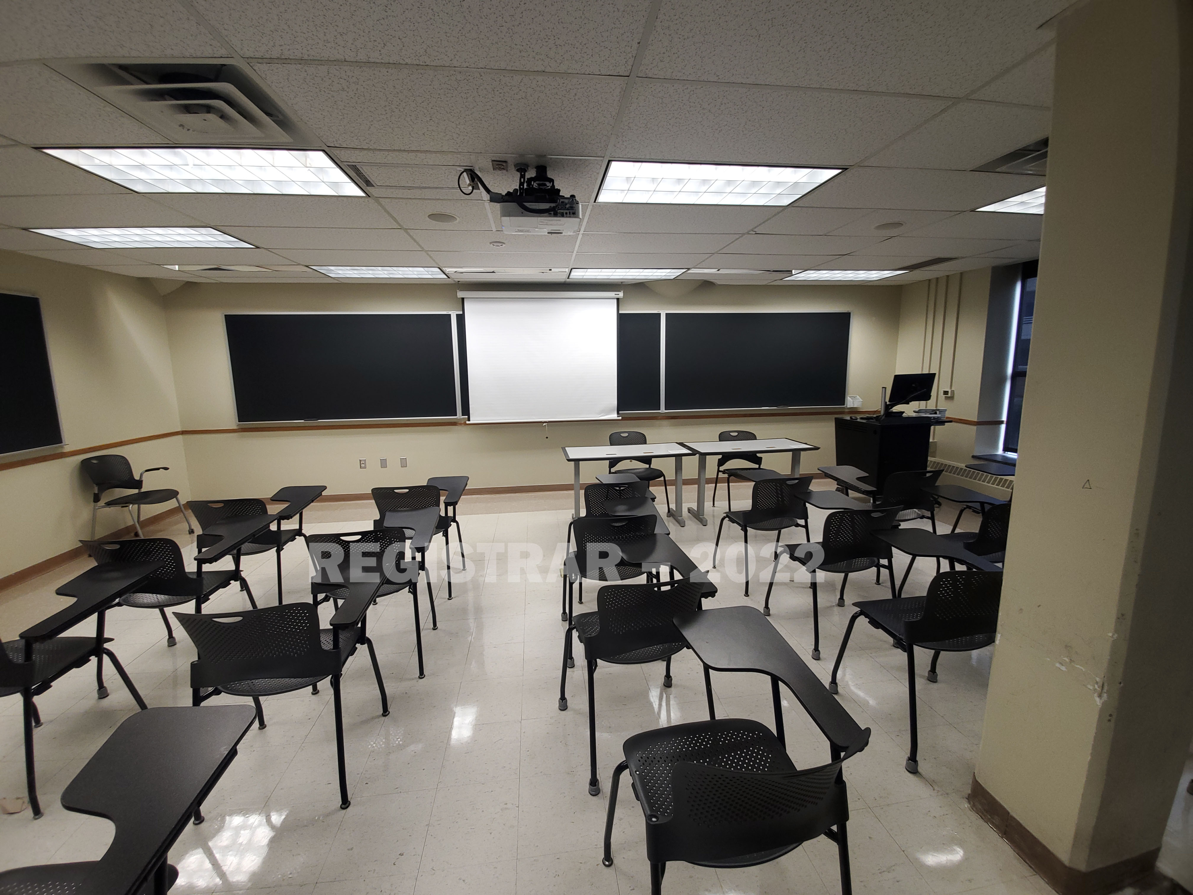 Enarson Classroom Building room 222 ultra wide angle view from the back of the room with projector screen down