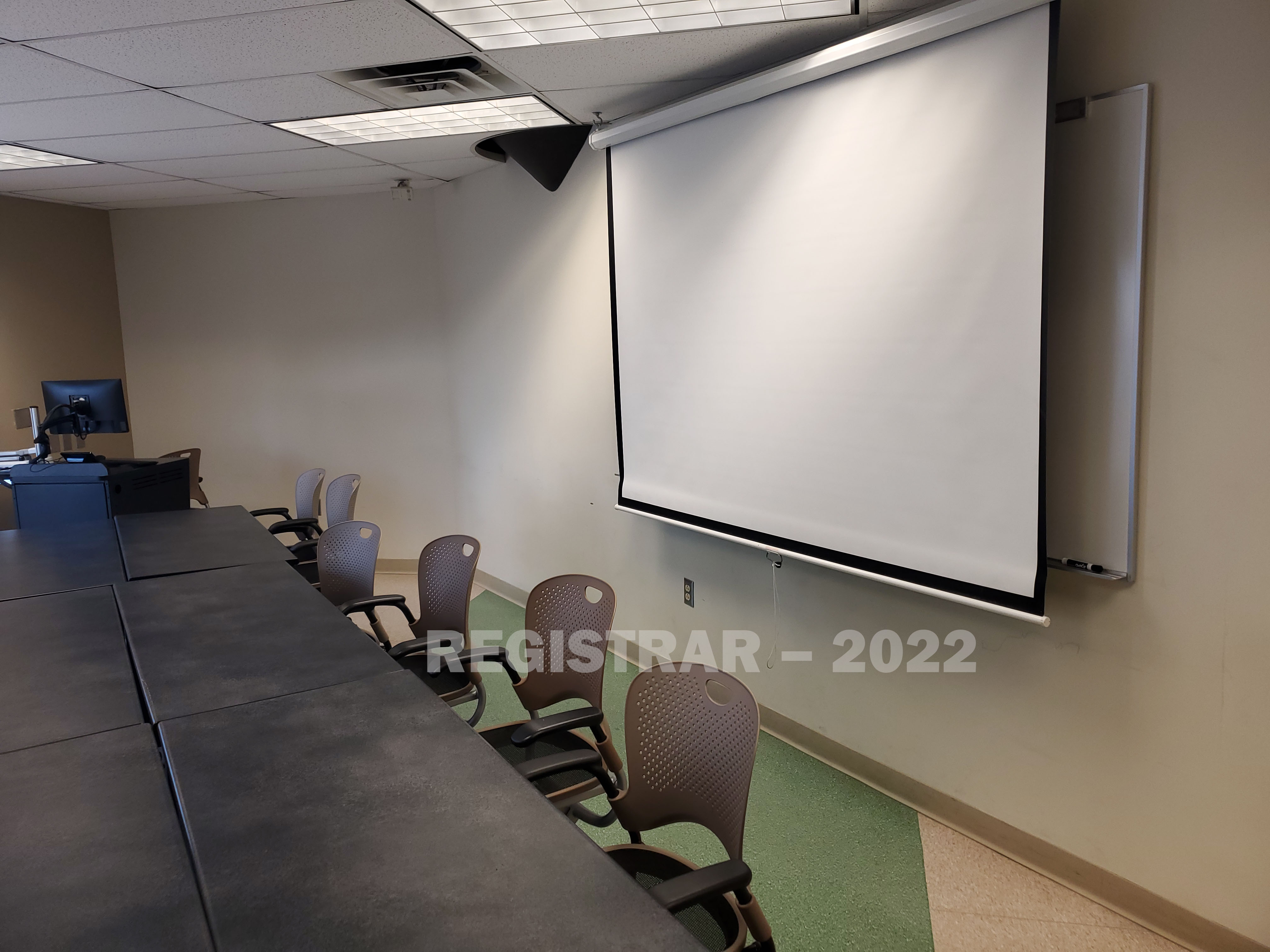 Enarson Classroom Building room 338 view from the back of the room with projector screen down