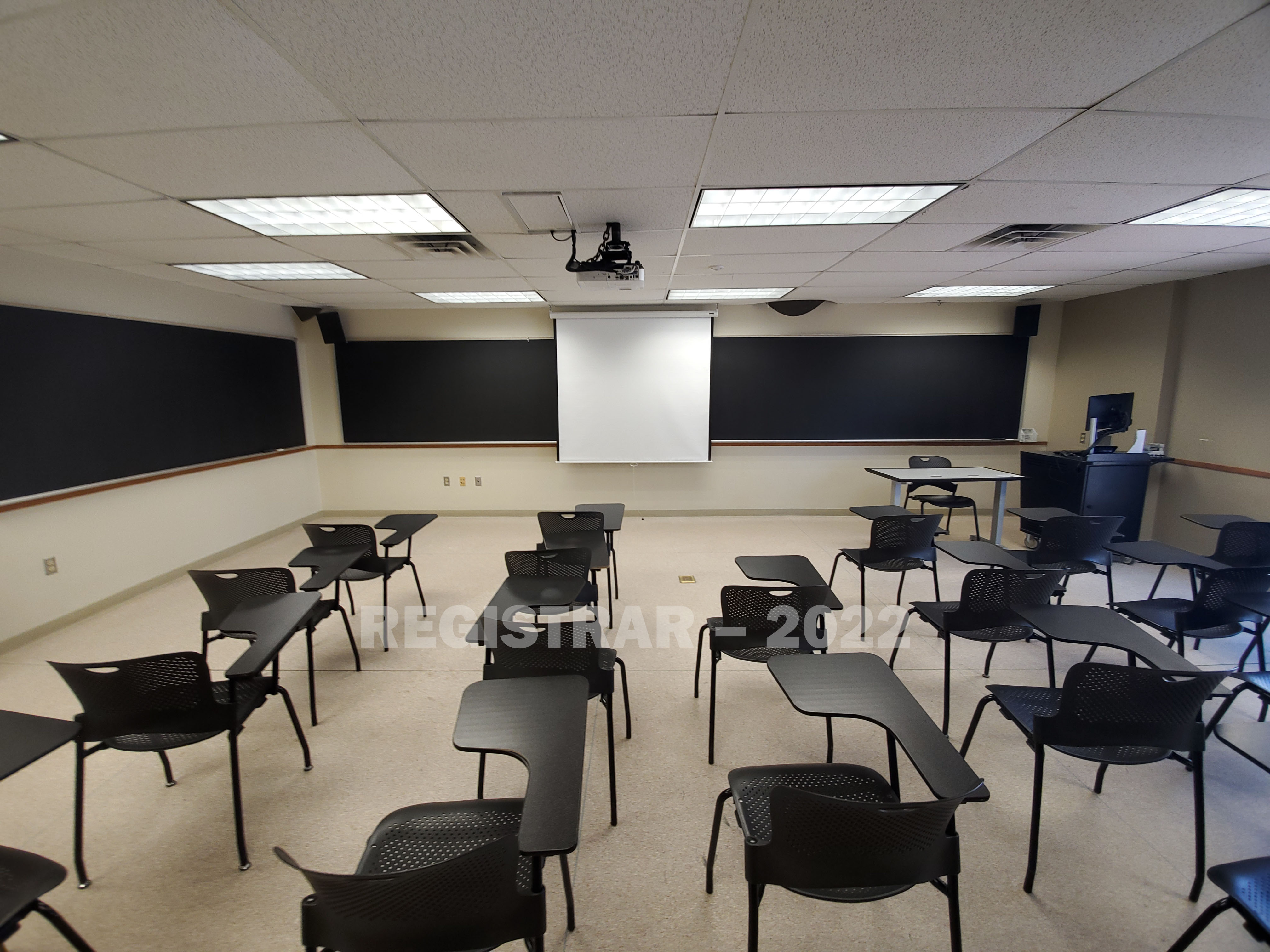 Enarson Classroom Building room 326 ultra wide angle view from the back of the room with projector screen down