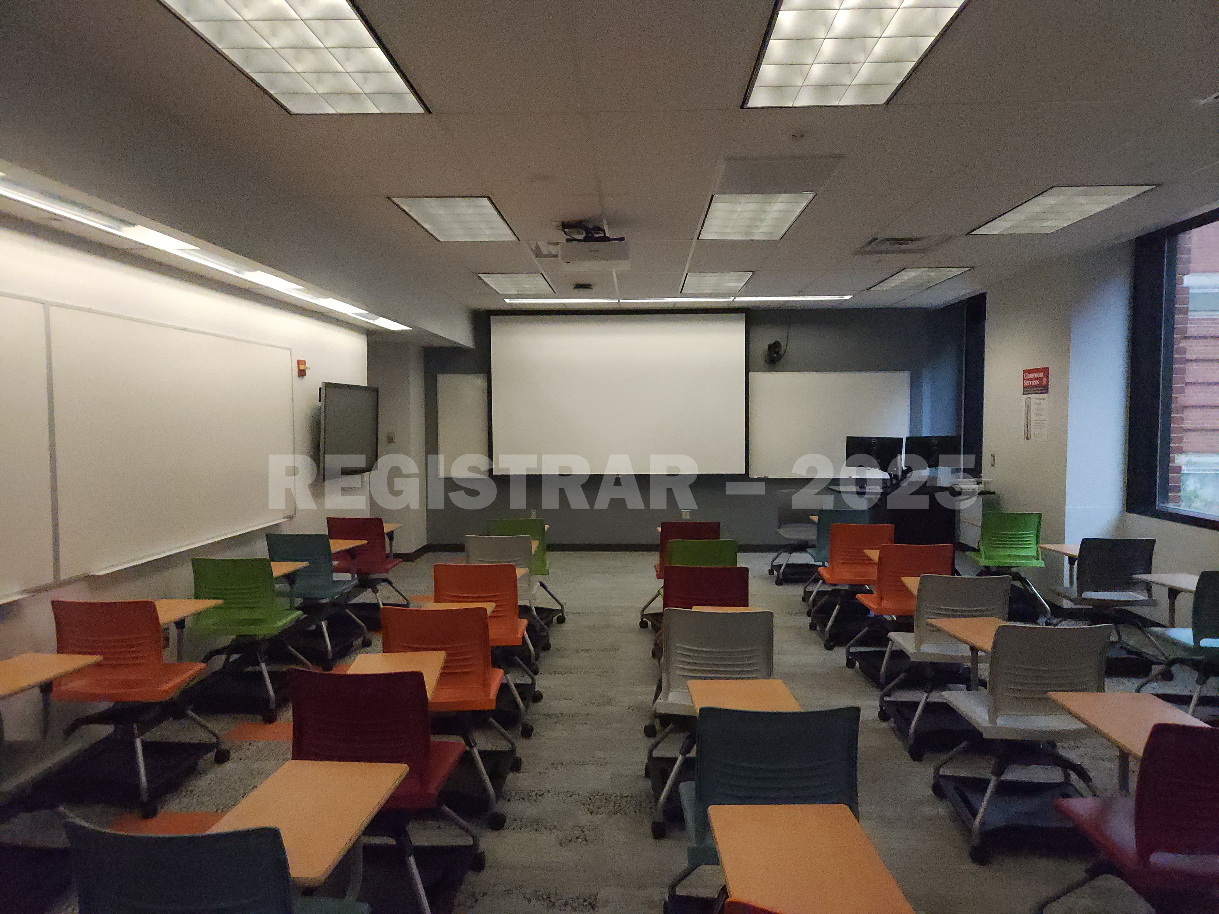 McPherson Chemical Lab room 1046 view from the back of the room with projection screen down