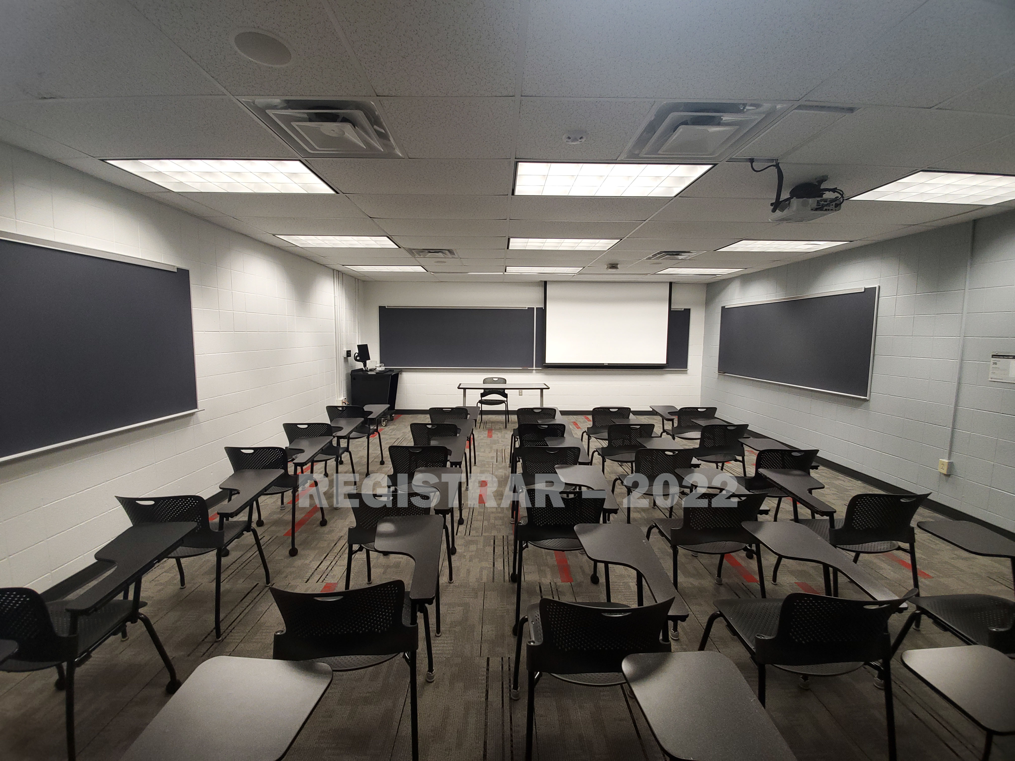 University Hall room 47 back of room projection screen down ultra wide angle view