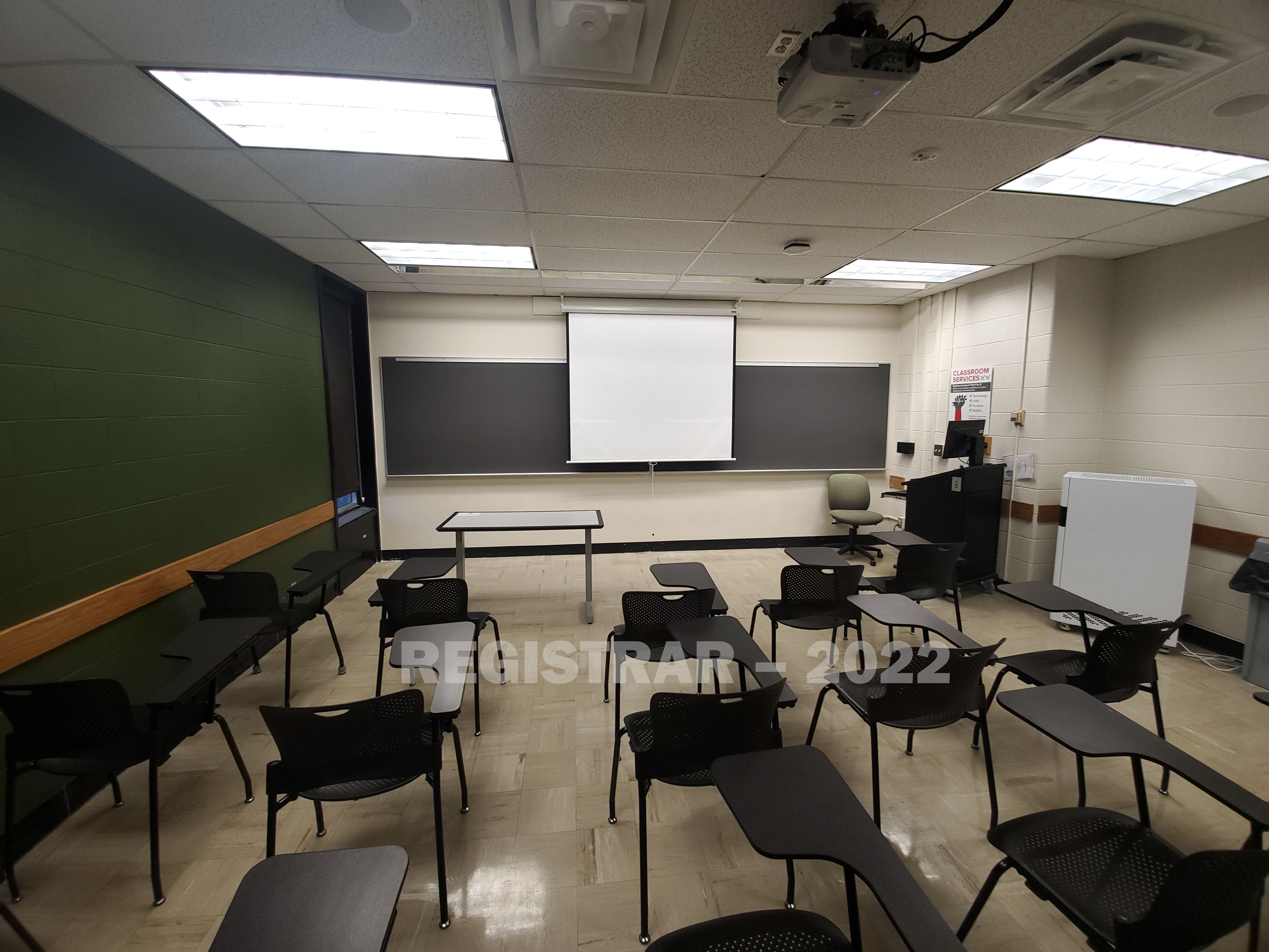 Baker Systems Engineering room 272 ultra wide angle view from the back of the room with projector screen down