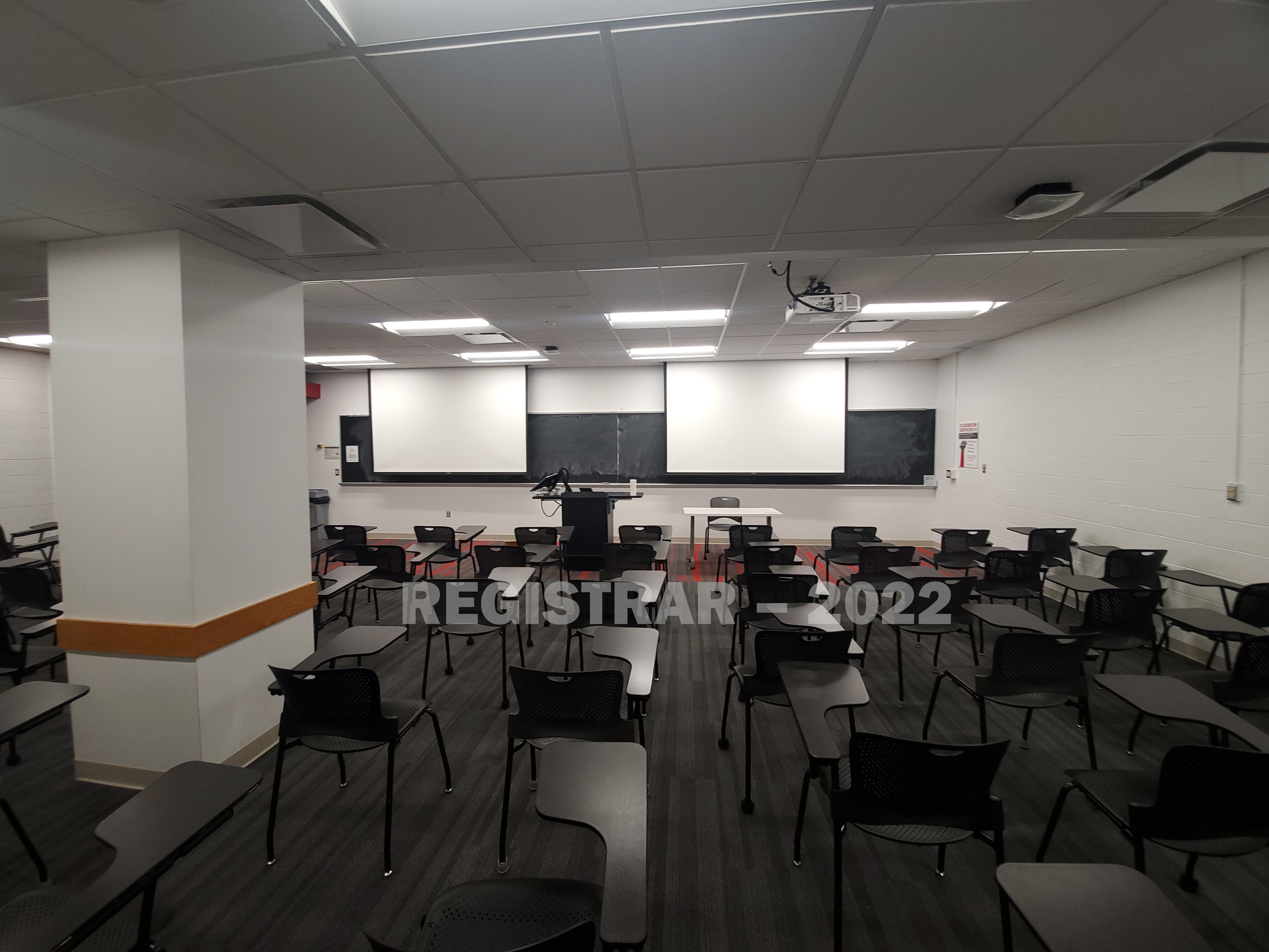 Baker Systems Engineering room 144 ultra wide angle view from the back of the room with projector screen down