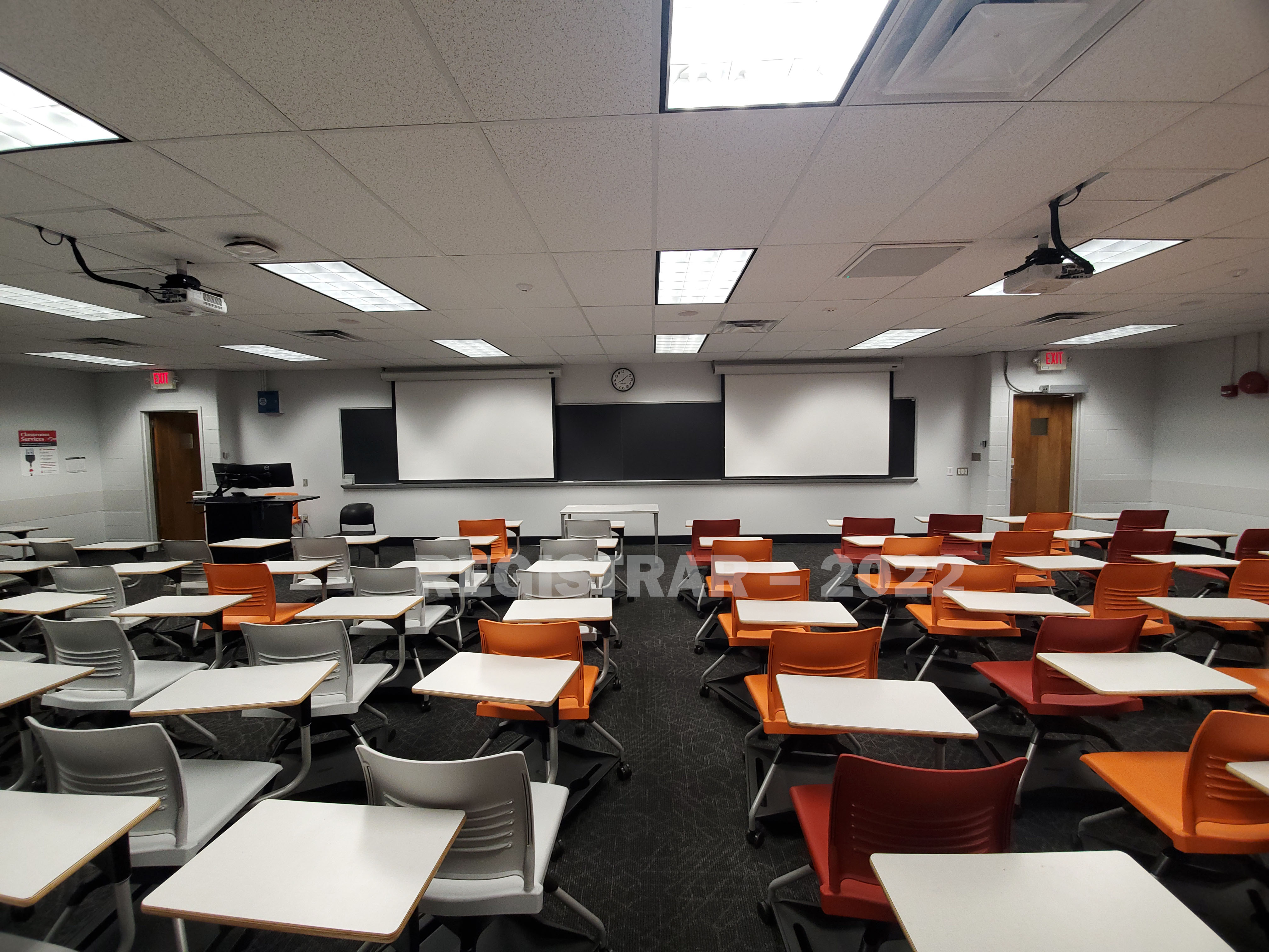 Journalism Building room 251 ultra wide angle view from the back of the room with projector screen down