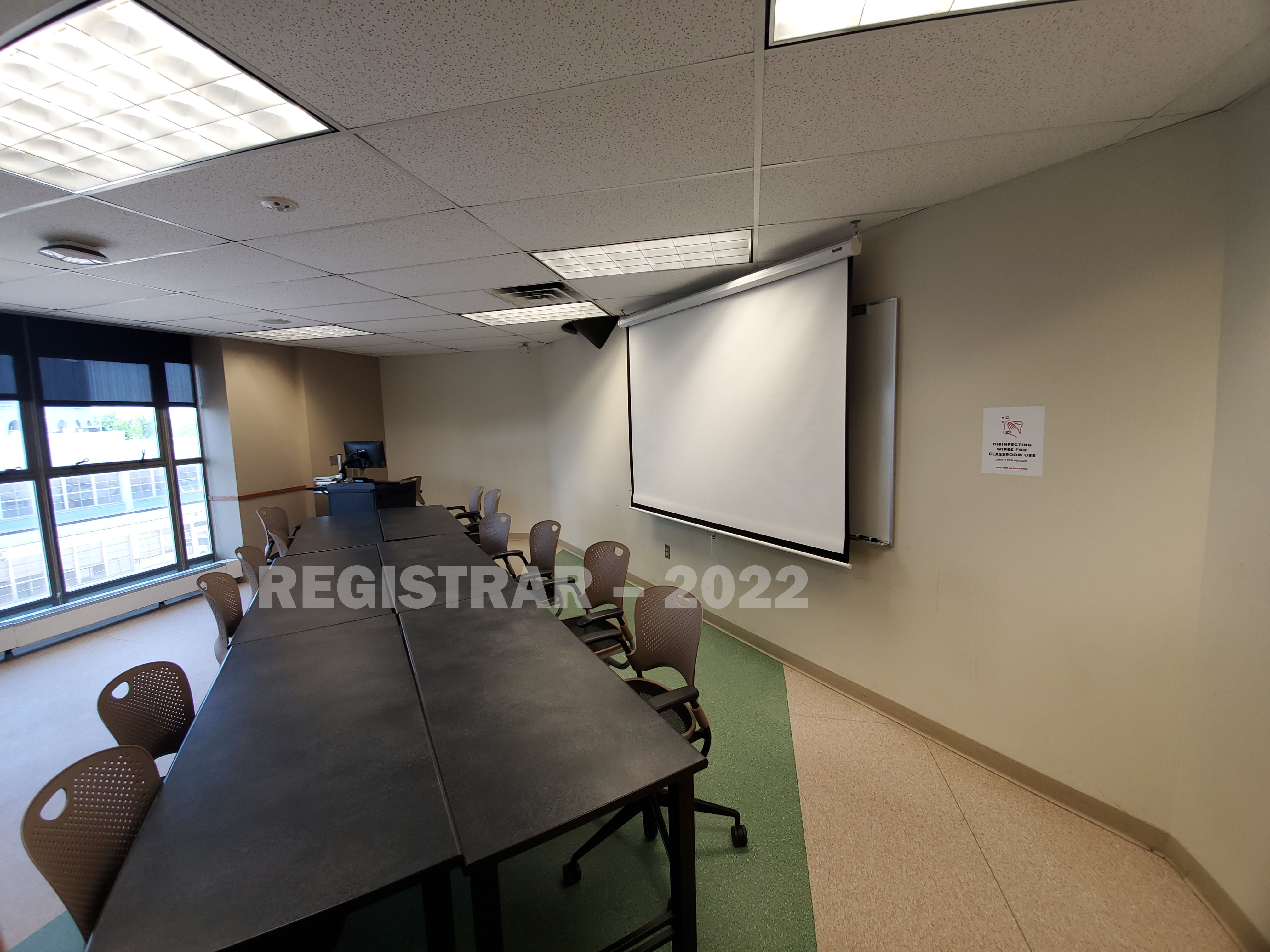Enarson Classroom Building room 338 ultra wide angle view from the back of the room with projector screen down