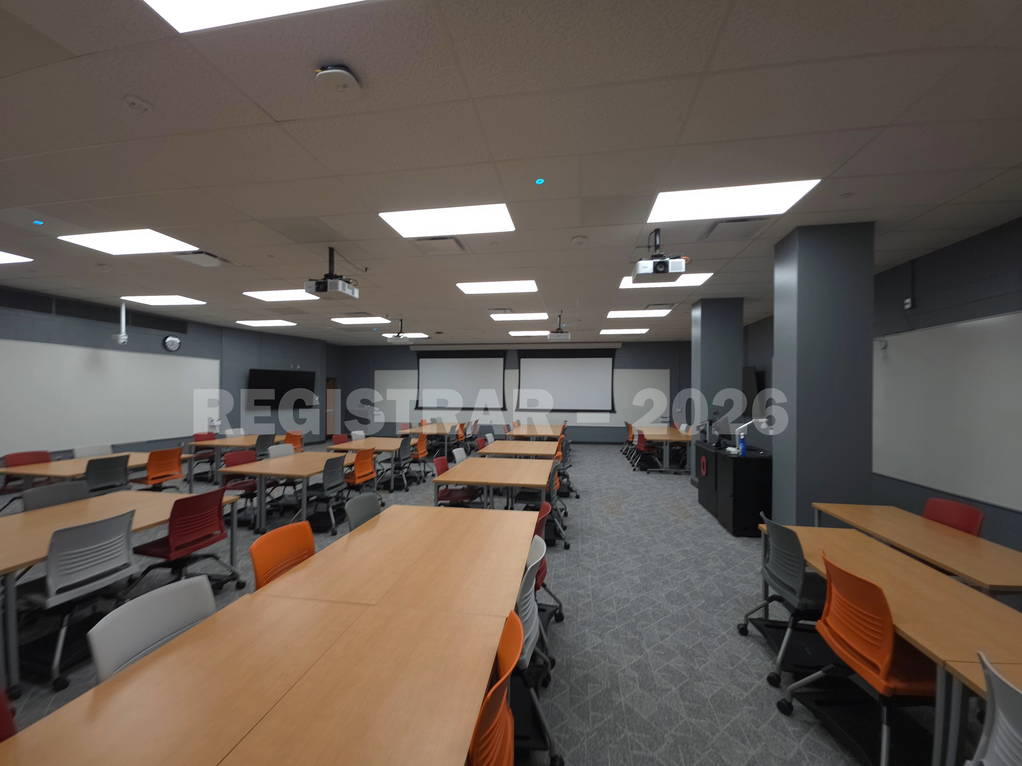 Agricultural Engineering Building room 100 ultra wide angle view from the left side of the room with the projector screens down