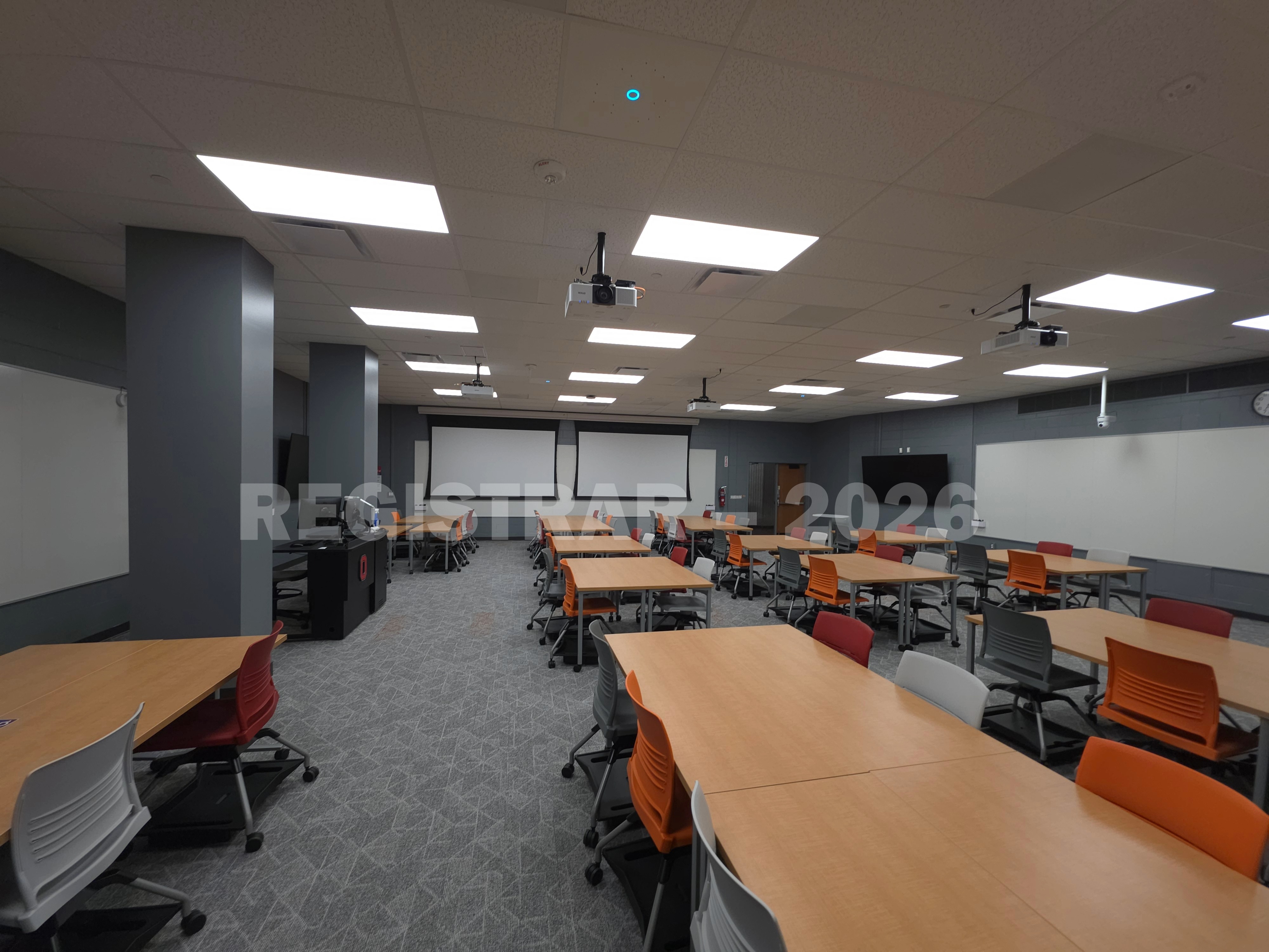 Agricultural Engineering Building room 100 ultra wide angle view from the right side of the room with the projector screens down