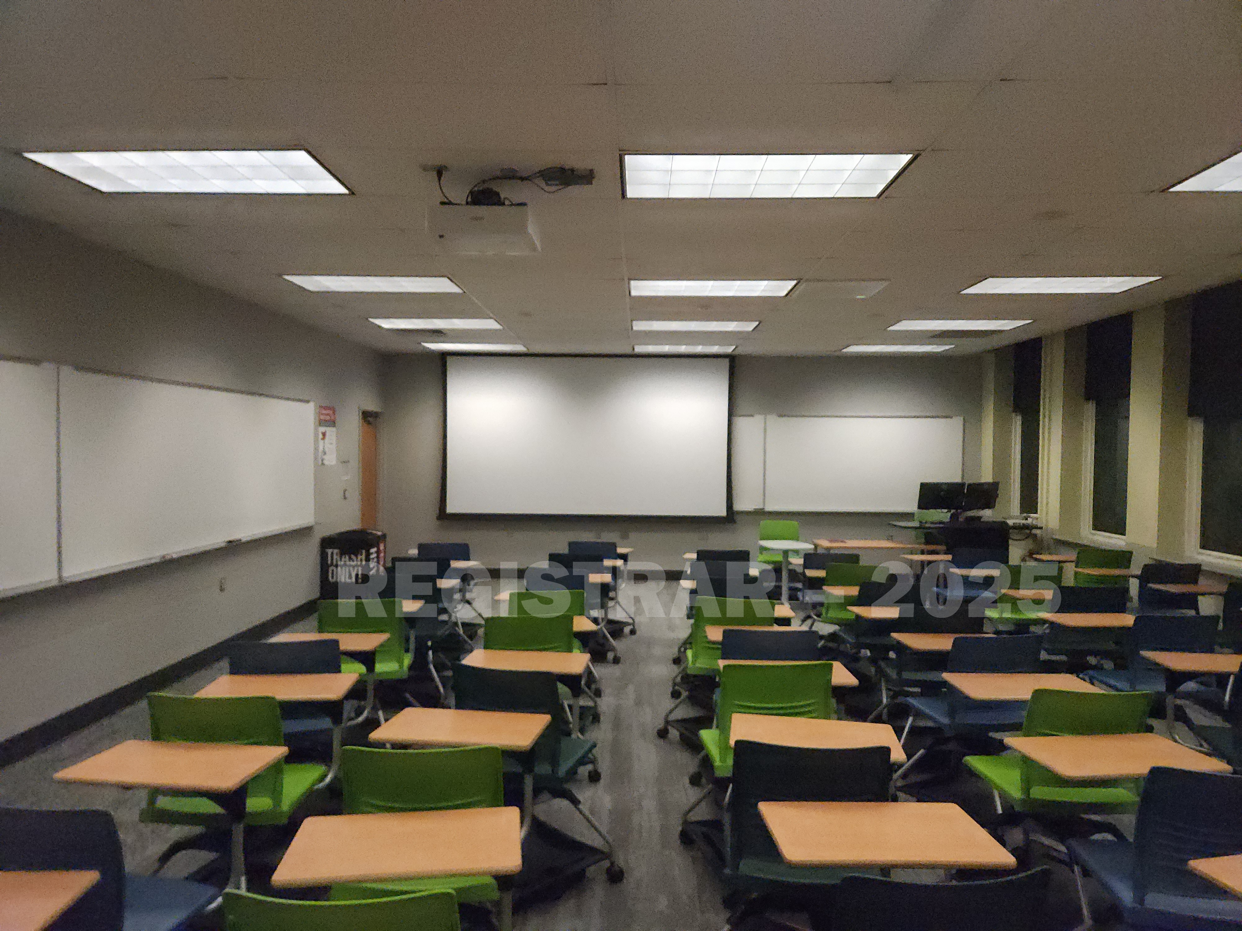 Mendenhall Laboratory room 115  view from the back of the room with projector screen down