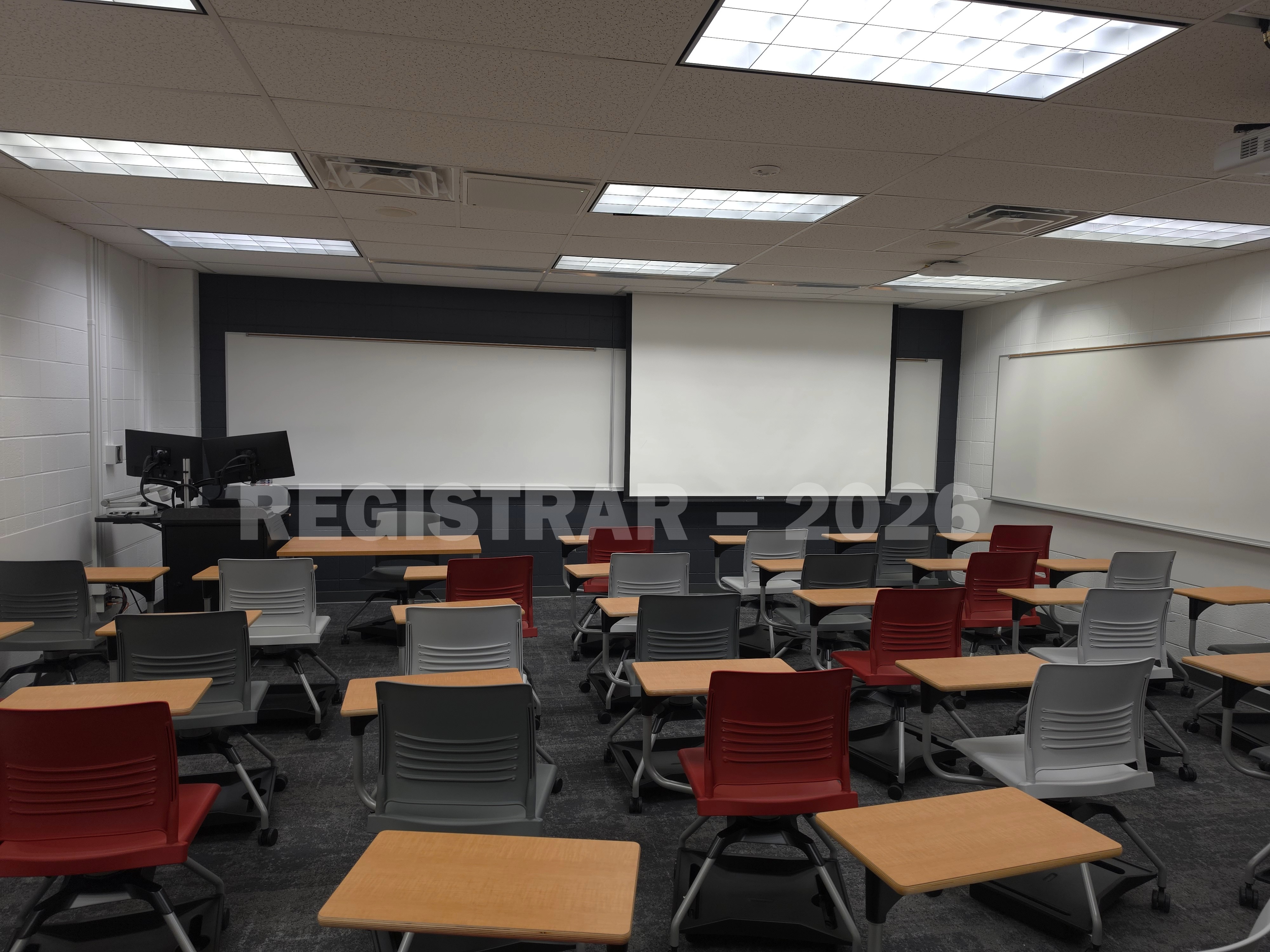 University Hall room 43 view from the back of the room with projector screen down