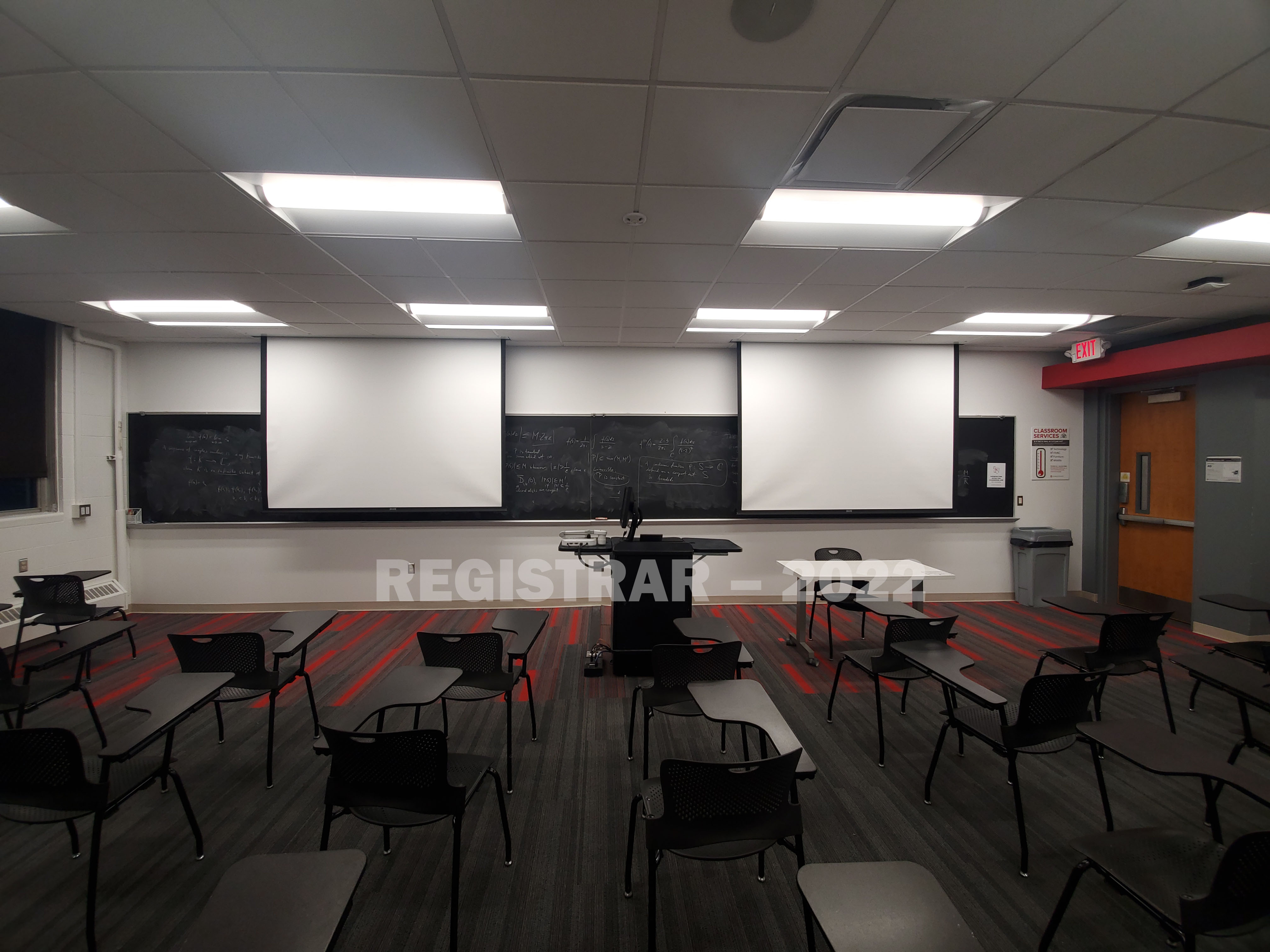 Baker Systems Engineering room 140 ultra wide angle view from the back of the room with projector screen down