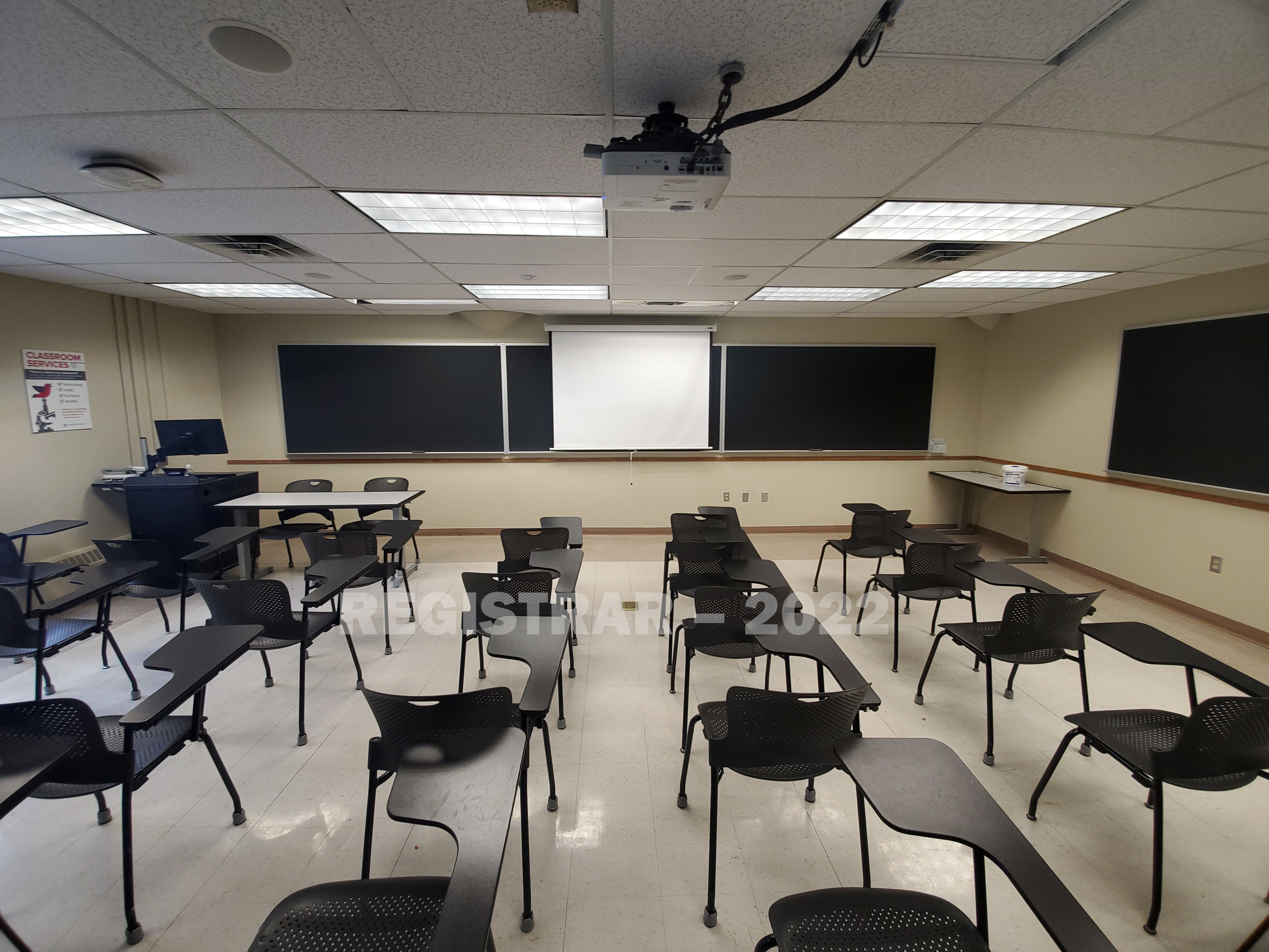 Enarson Classroom Building room 258 ultra wide angle view from the back of the room with projector screen down