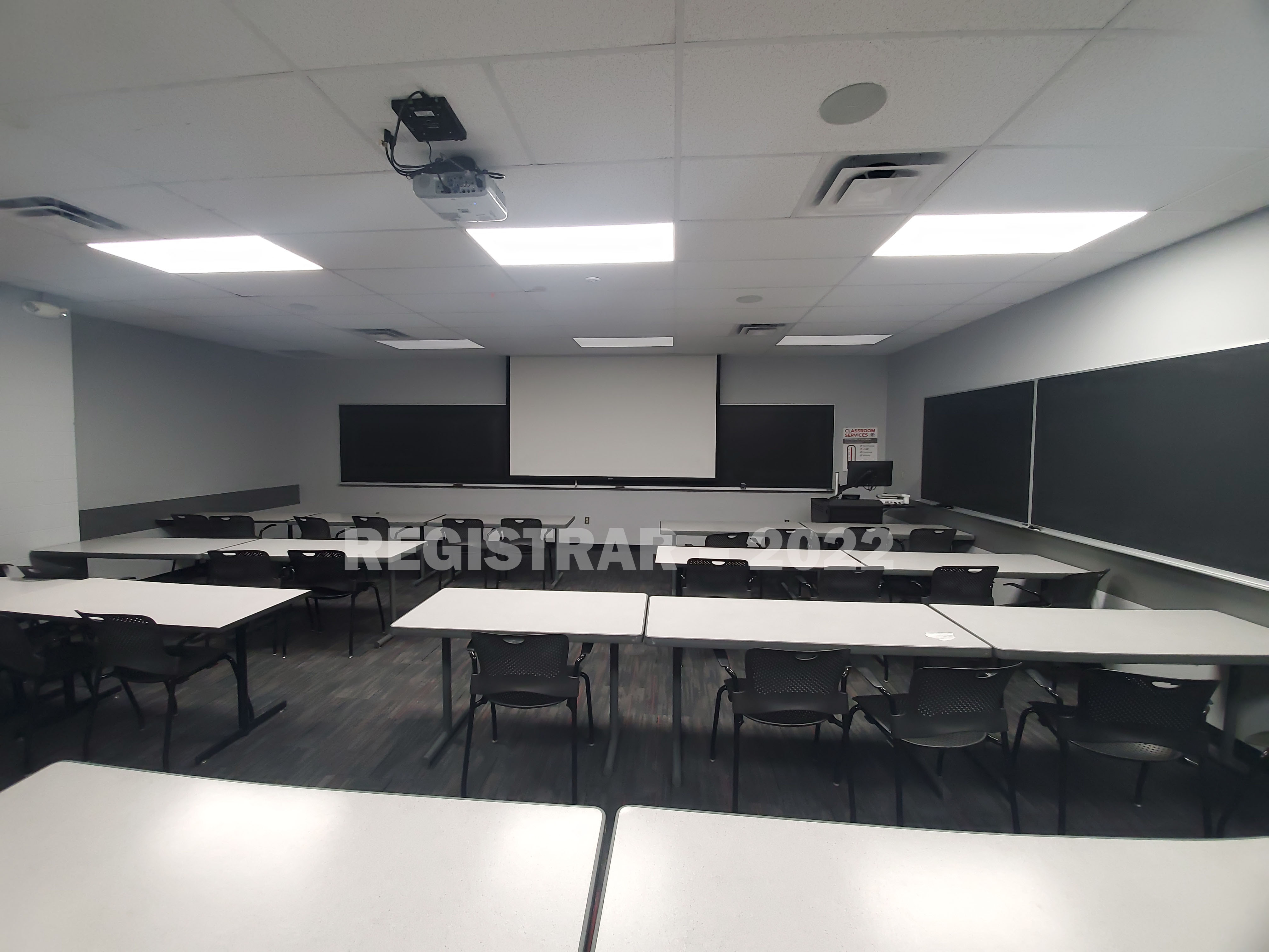 Baker Systems Engineering room 148 ultra wide angle view from the back of the room with projector screen down