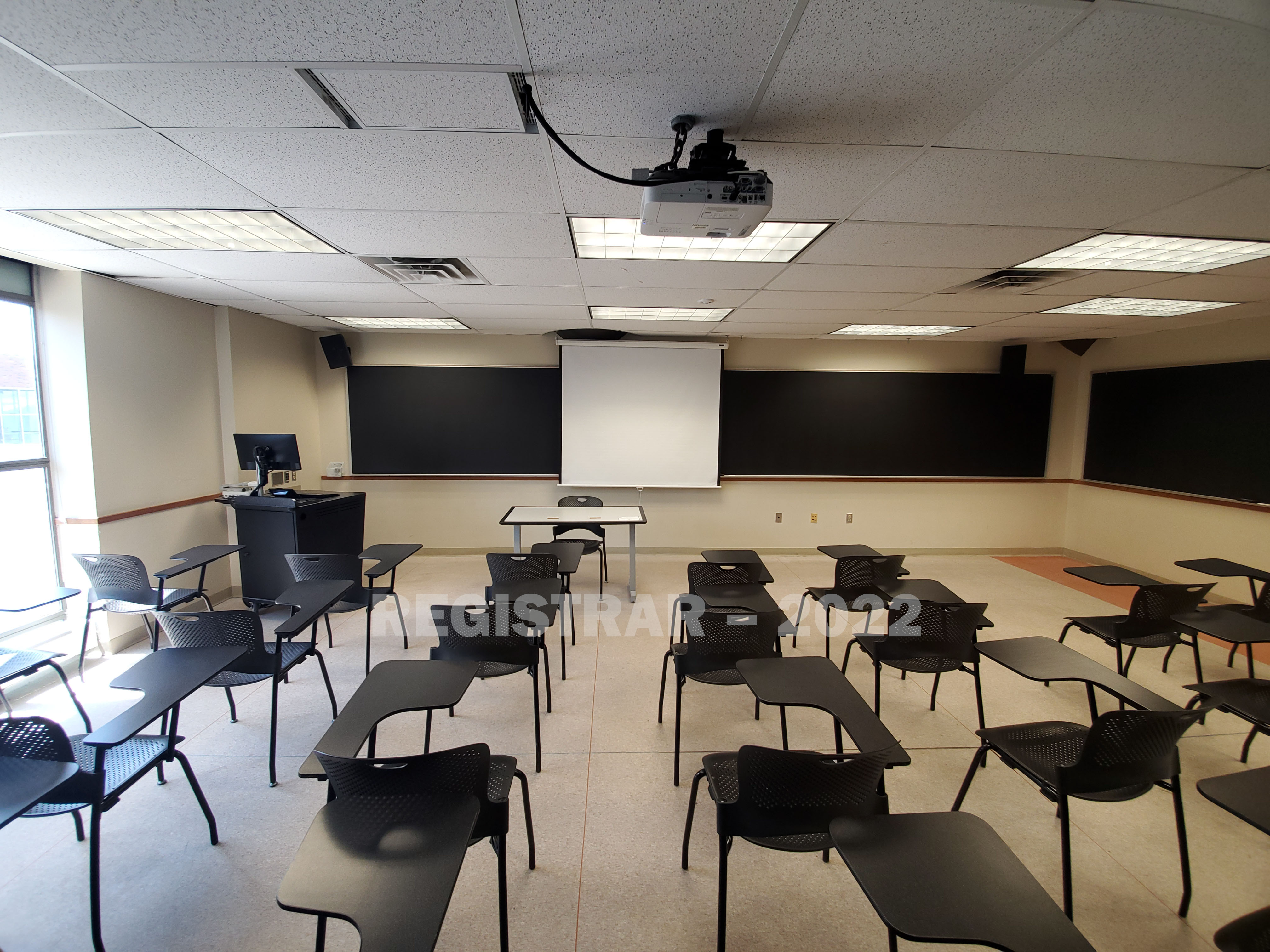 Enarson Classroom Building room 358 ultra wide angle view from the back of the room with projector screen down