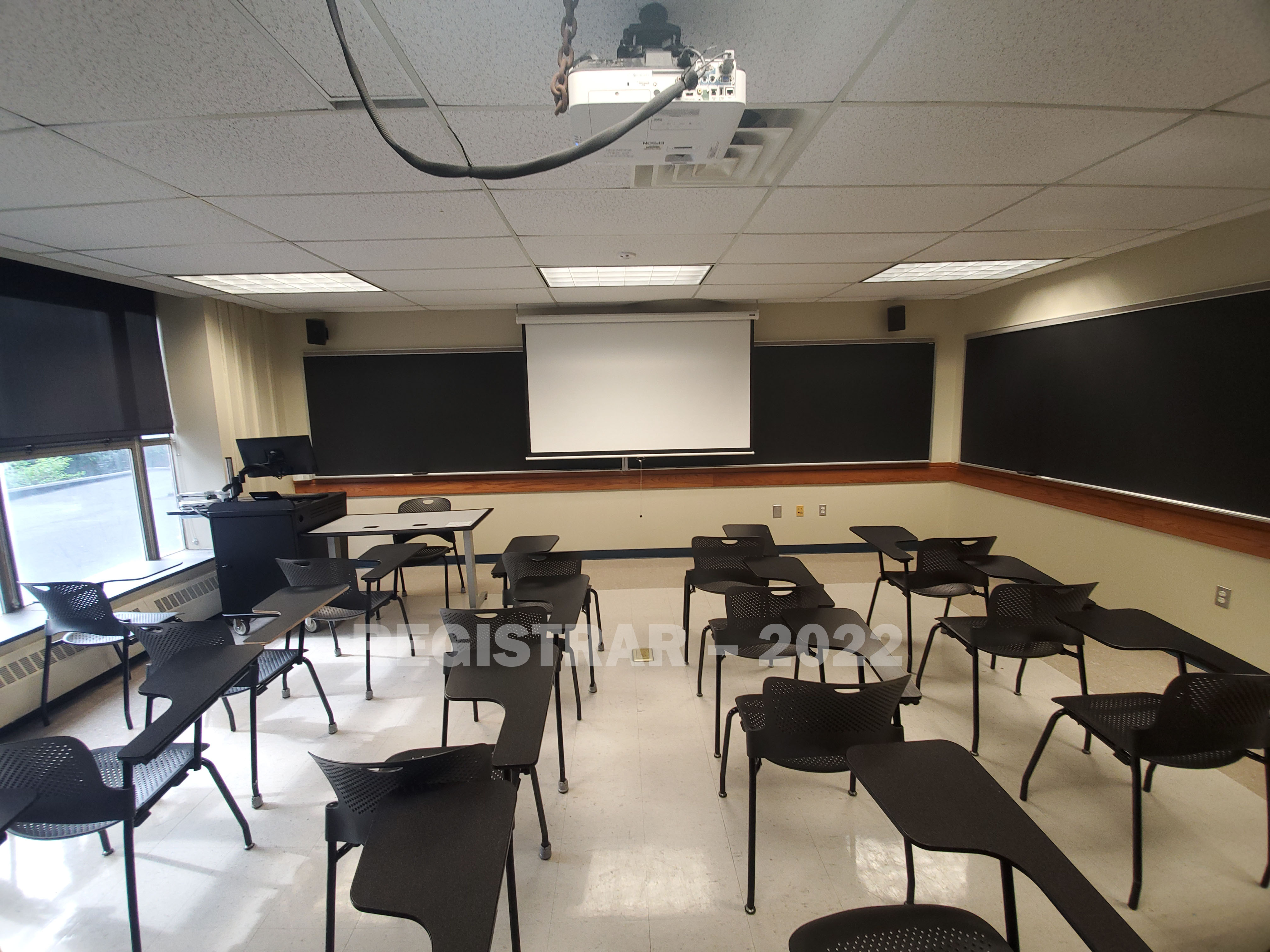 Enarson Classroom Building room 204 ultra wide angle view from the back of the room with projector screen down