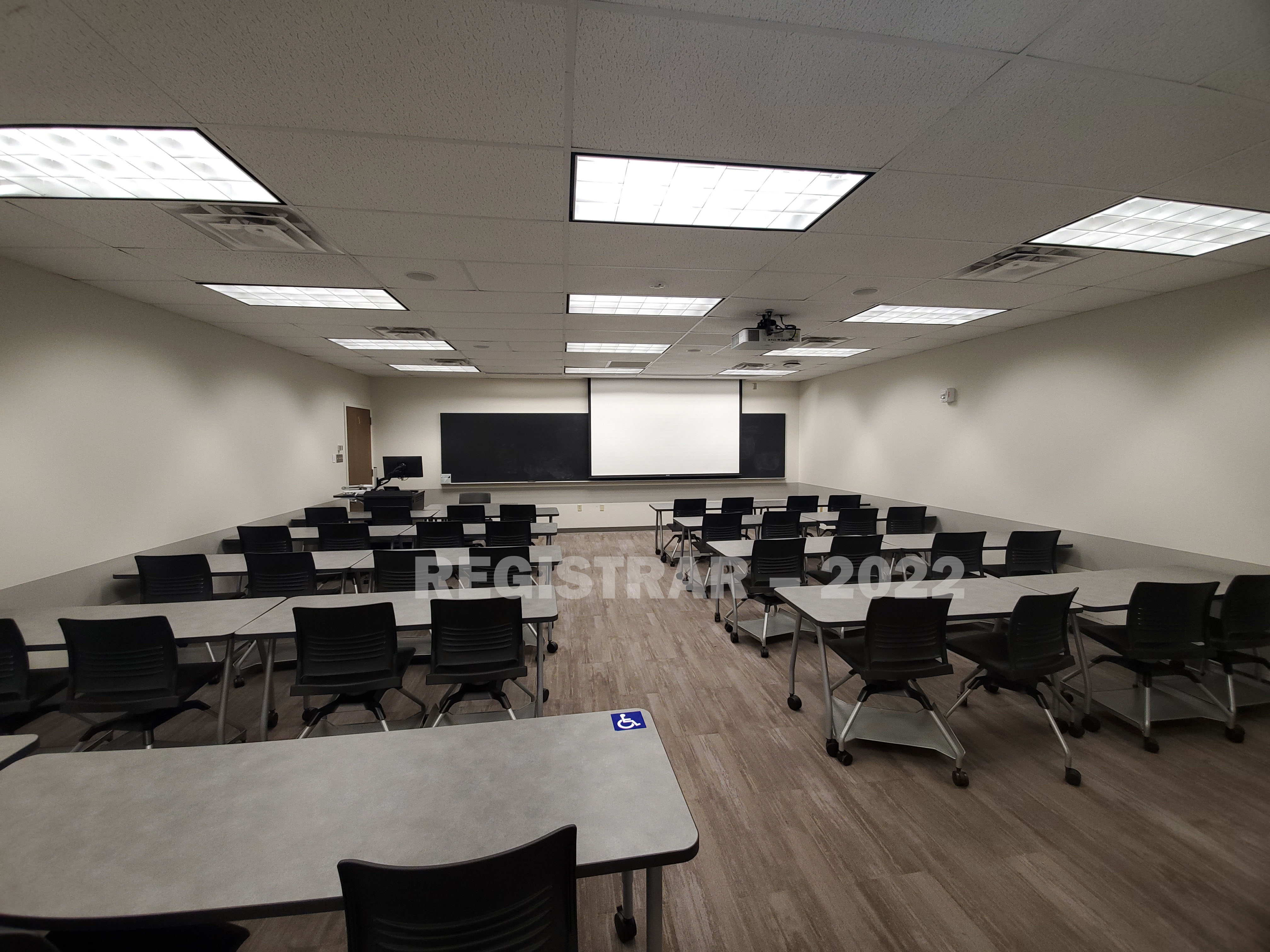 Dreese Lab room 317 ultra wide angle view from the back of the room with projector screen down